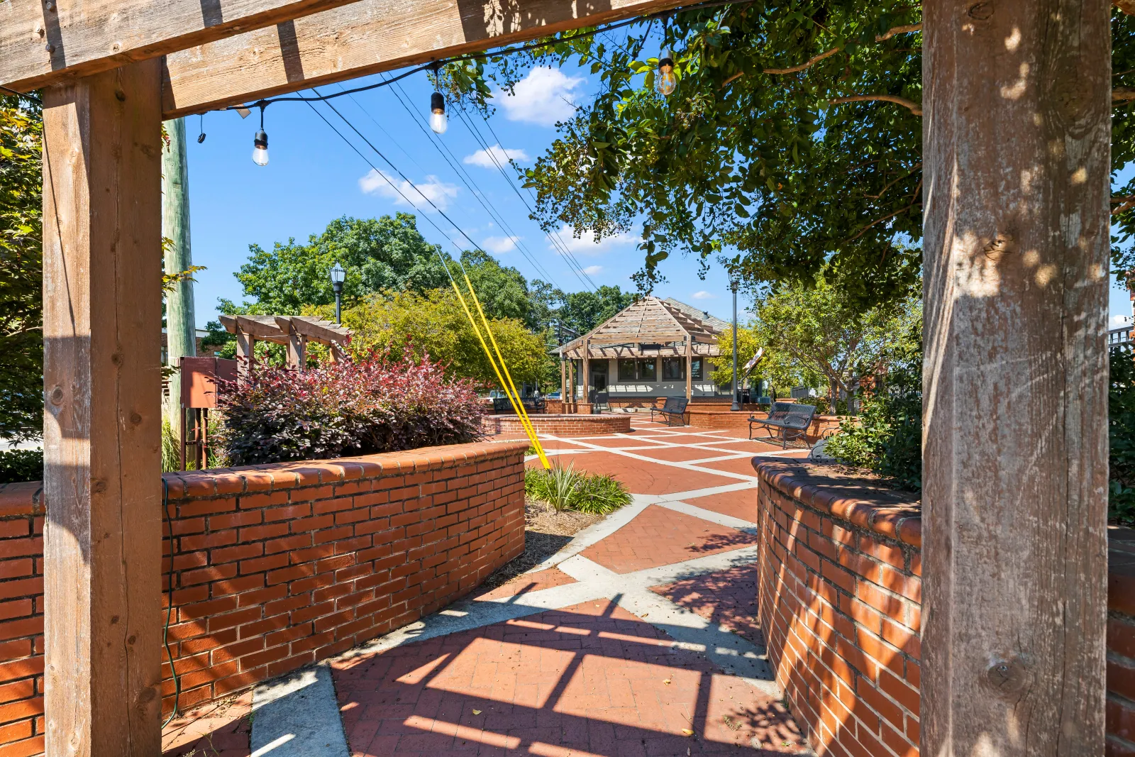 a brick patio with a brick wall and a brick wall with a brick walkway and a brick wall