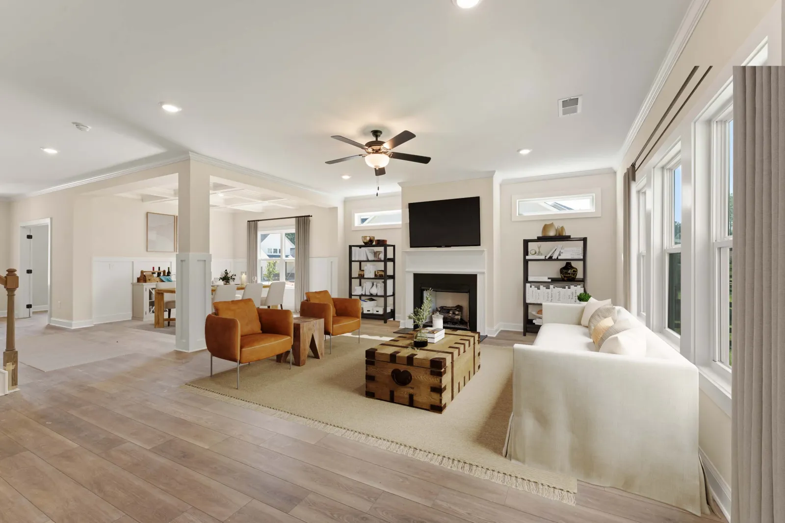 a living room with a large white couch and a wood floor