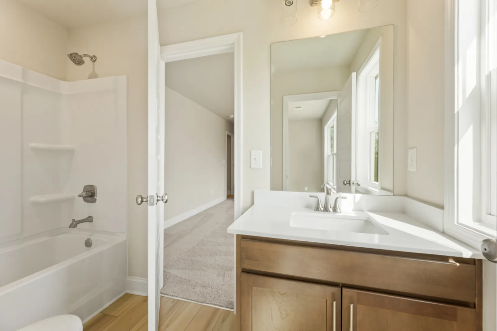 a bathroom with a tub sink and a mirror