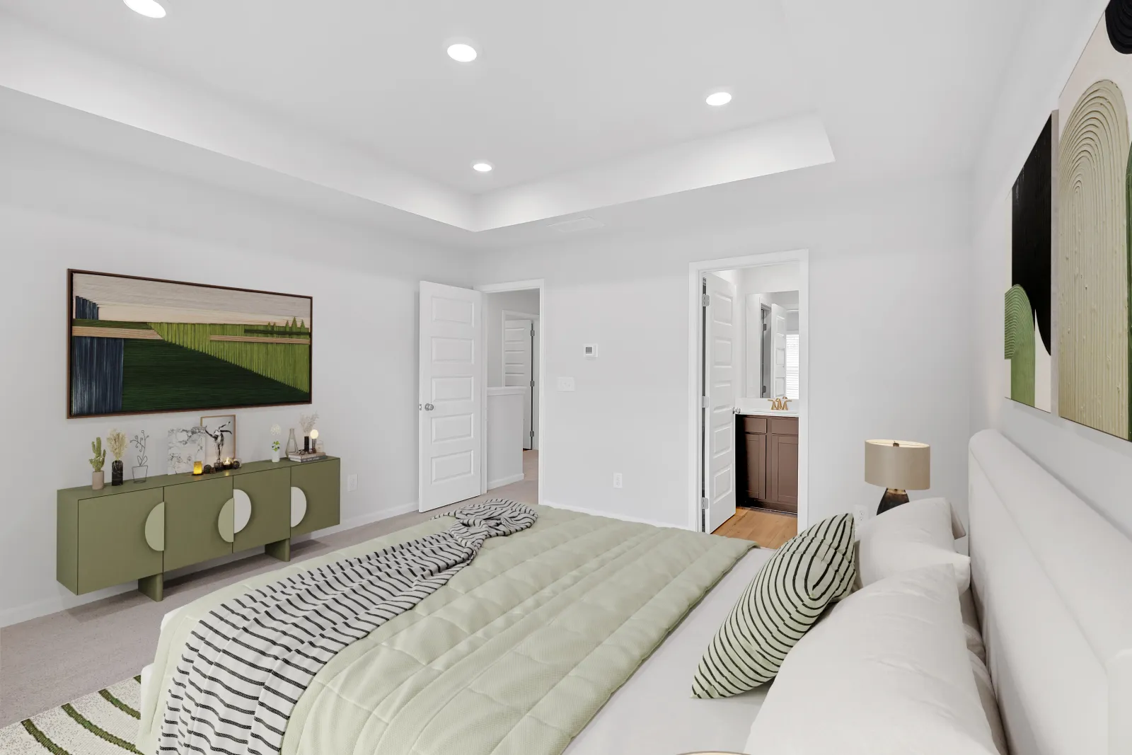 Modern bedroom featuring neutral colors, plush bedding, and contemporary decor with green accents.