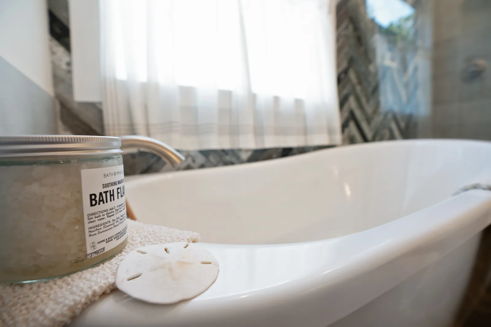 a white bathtub with a soap dispenser and a soap dispenser