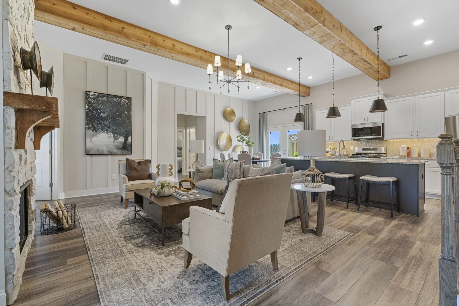 a large living room with a bar and chairs