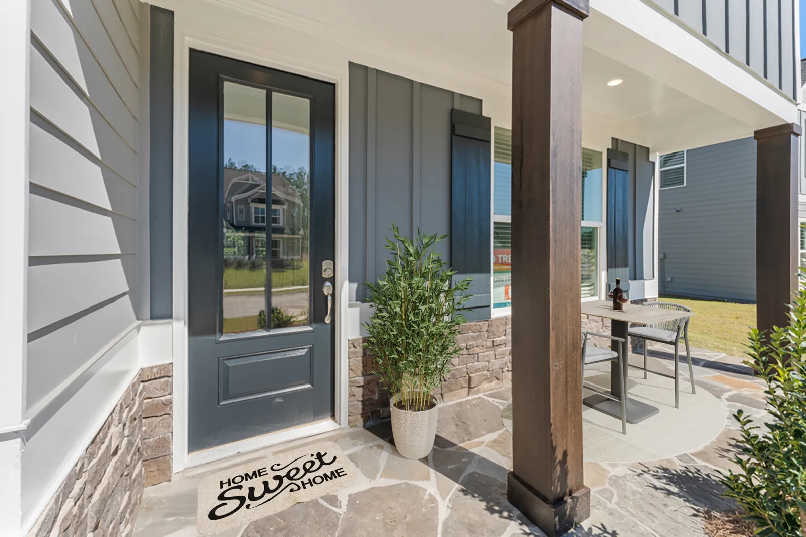 a building with a glass door and a table and a plant