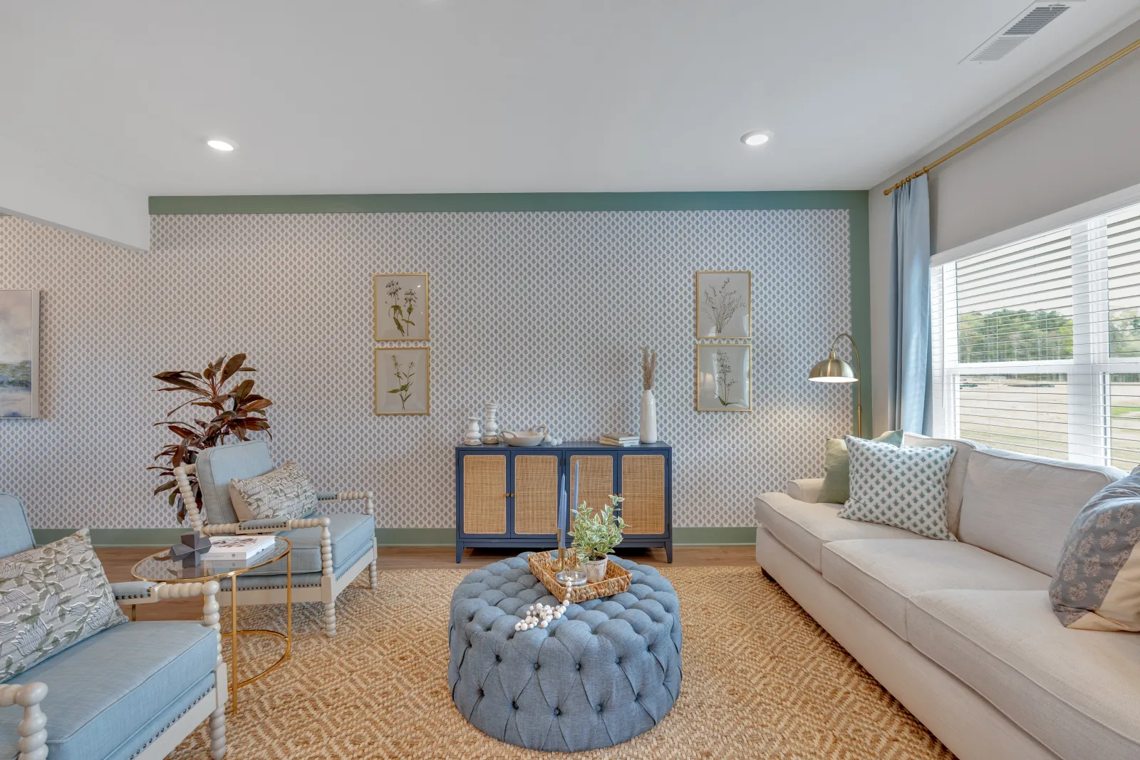 Bright, modern living room with blue accents, plush seating, and stylish decor elements.