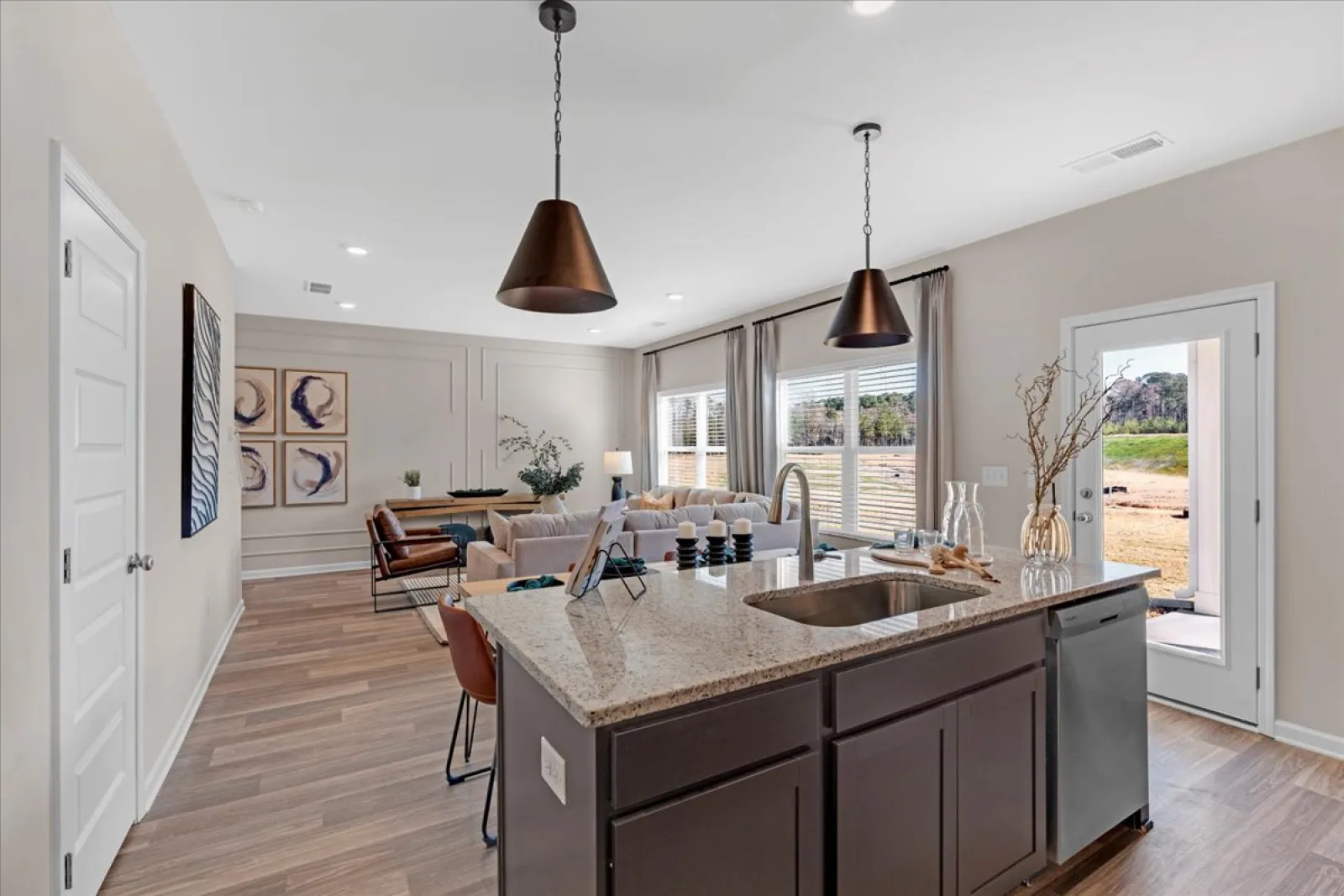 Modern kitchen and living area with stylish decor and outdoor view in a home interior.