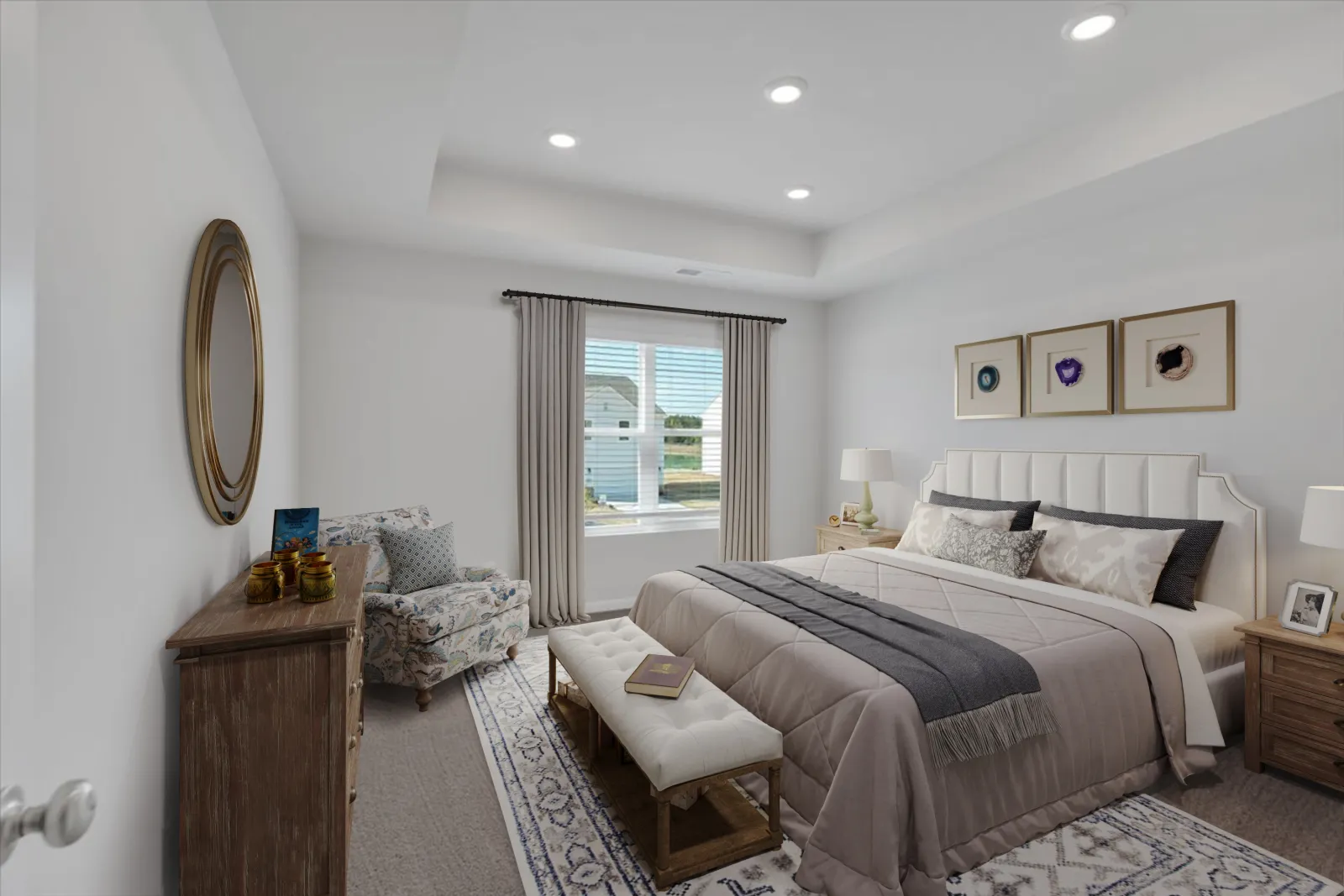 Bright bedroom with beige bedding, patterned armchair, wooden furniture, large window, and decorative wall art.