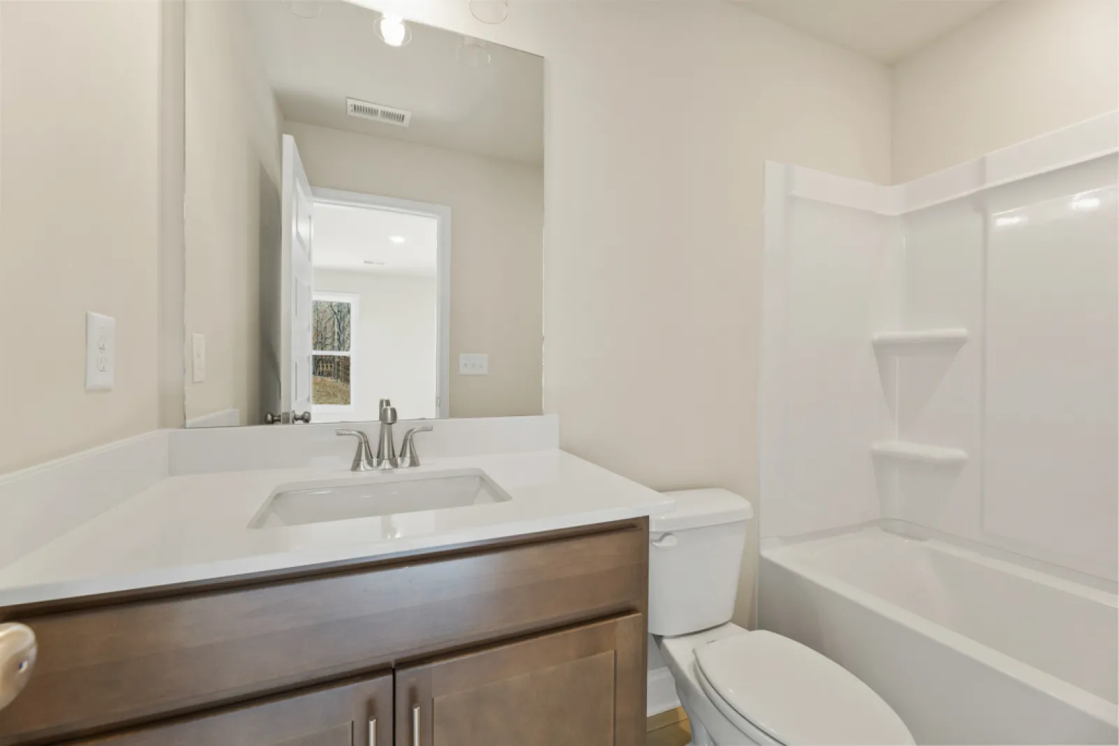 a bathroom with a tub sink and toilet