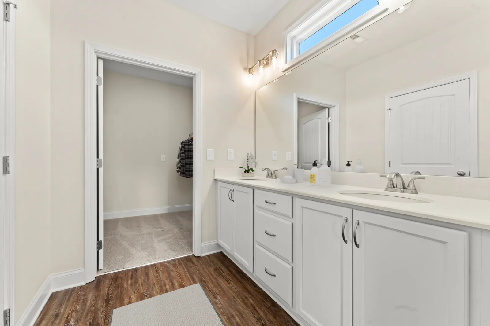 a bathroom with white cabinets