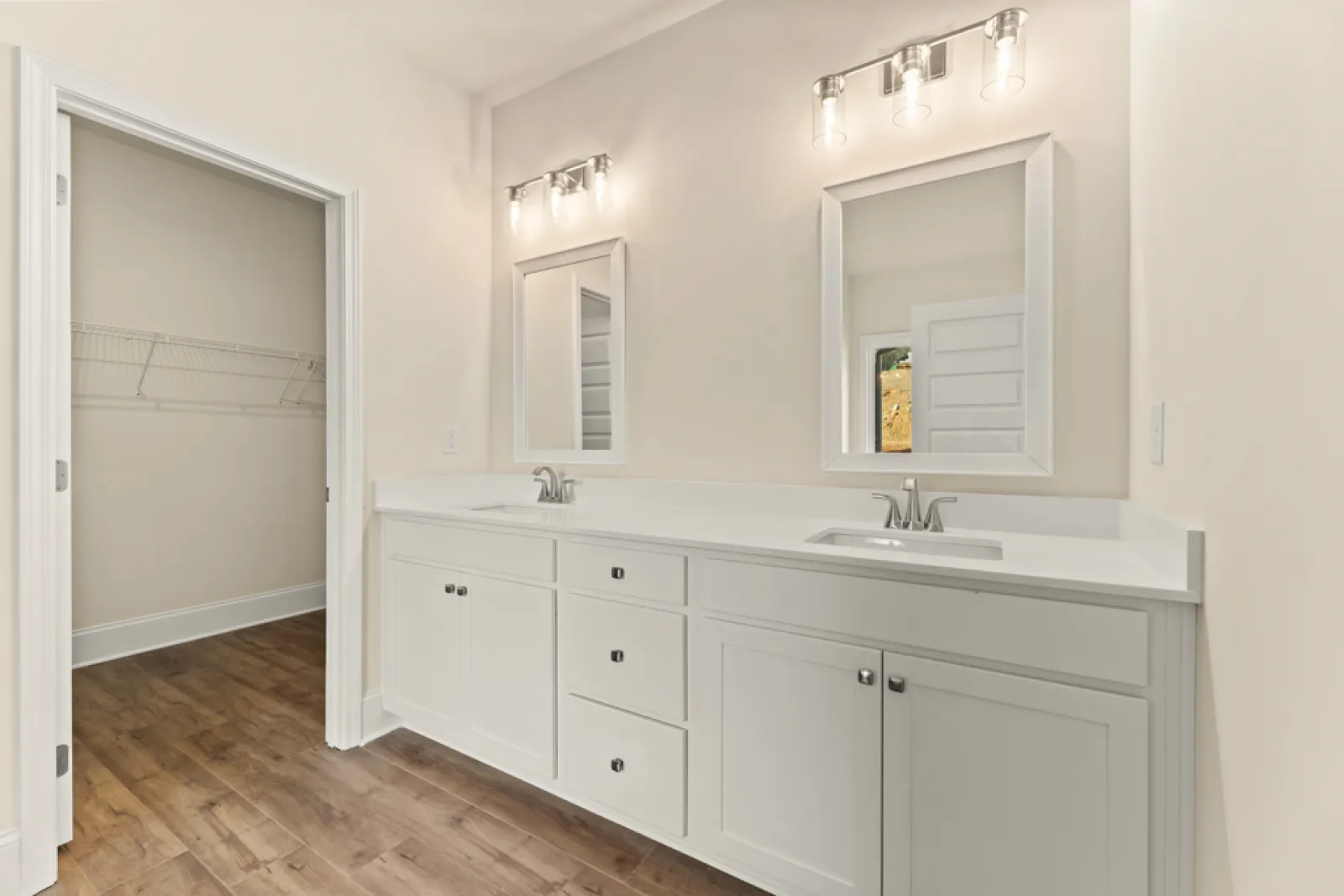 a bathroom with white cabinets