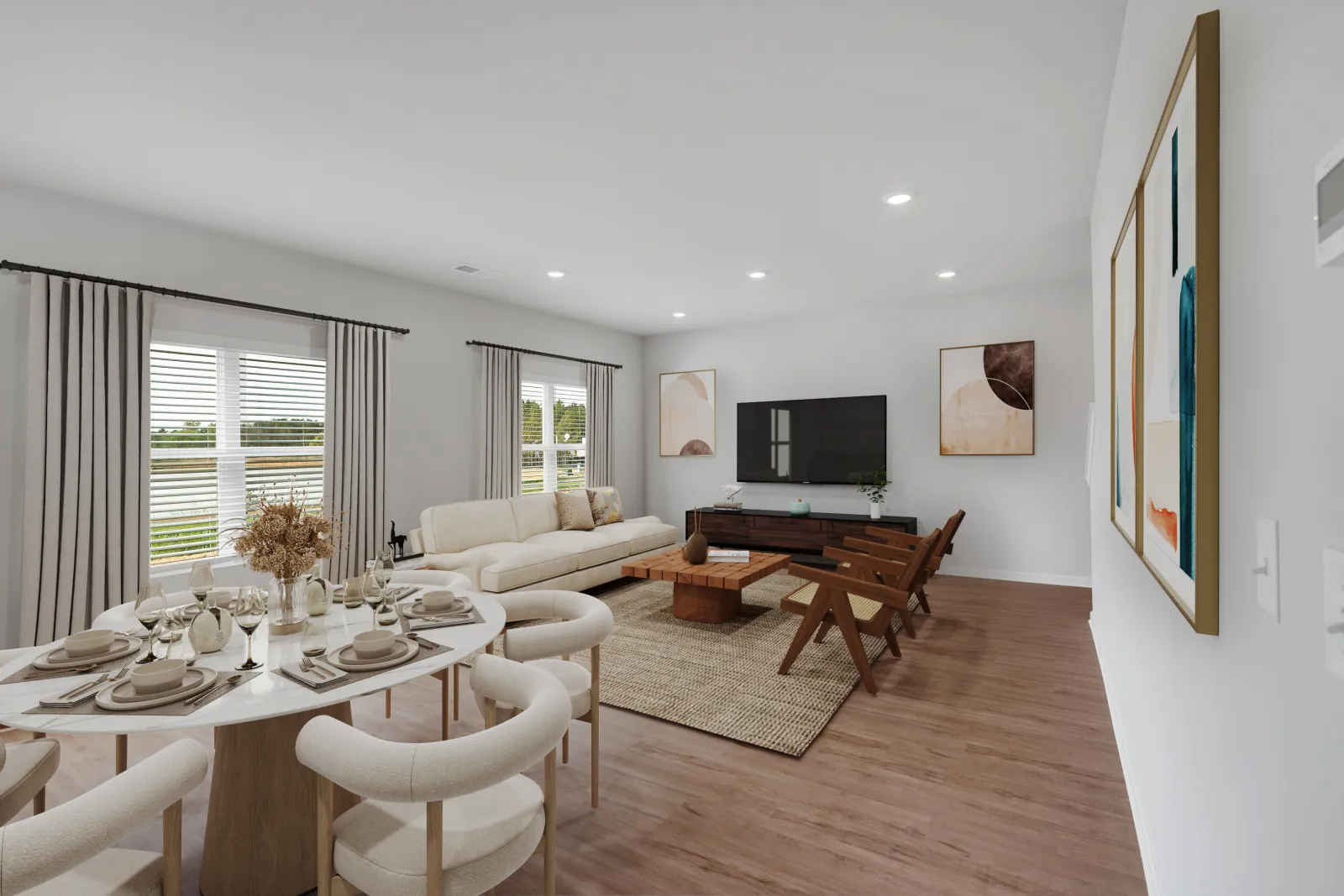 Modern living room with white sofa, wooden chairs, round dining table set, neutral decor, and large windows with curtains