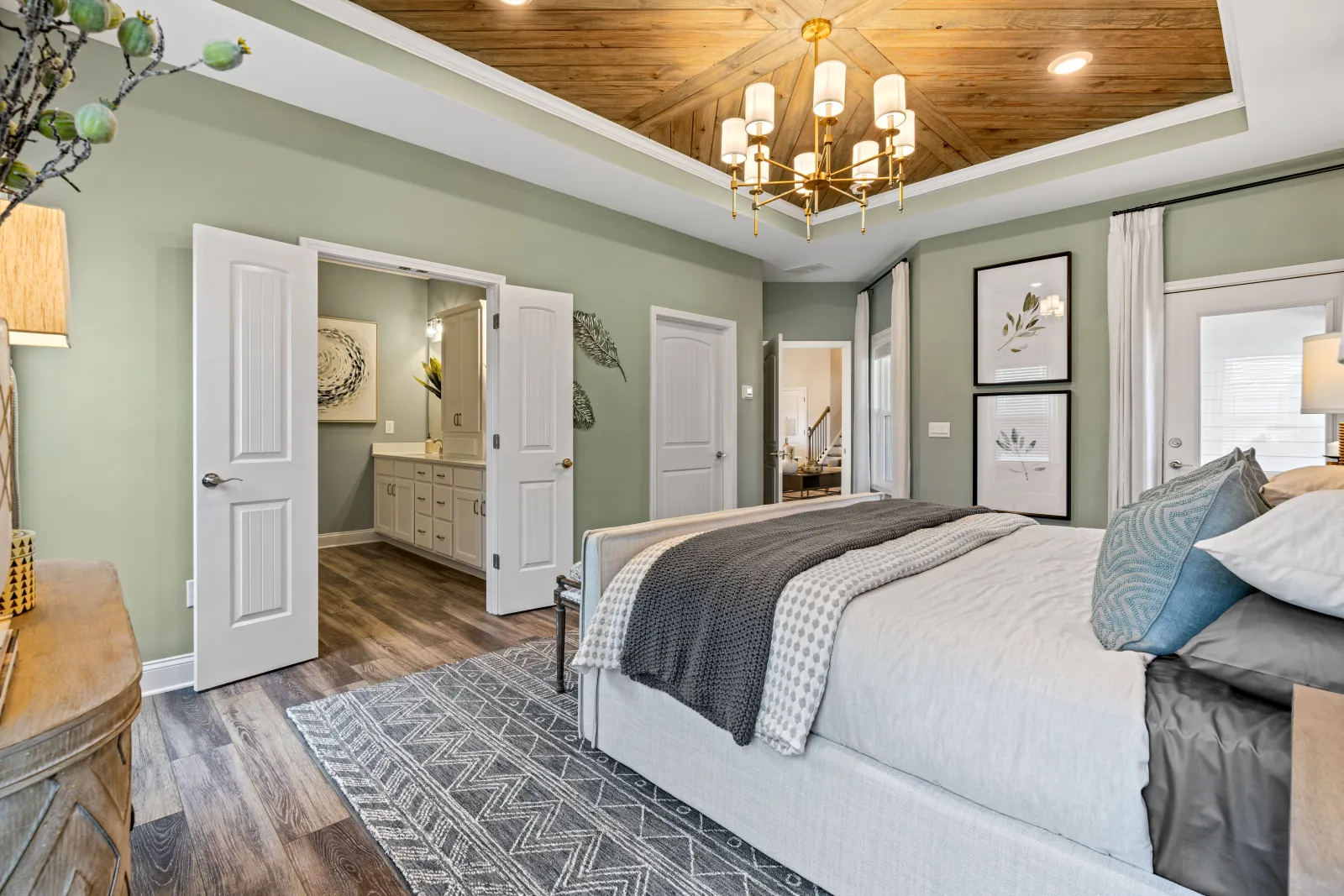 a bedroom with a bed and a chandelier