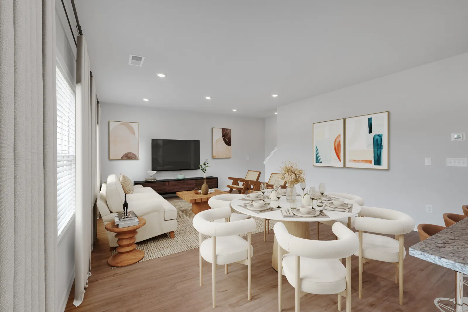 Modern open living room and dining area with neutral decor, white chairs, and abstract art on walls.