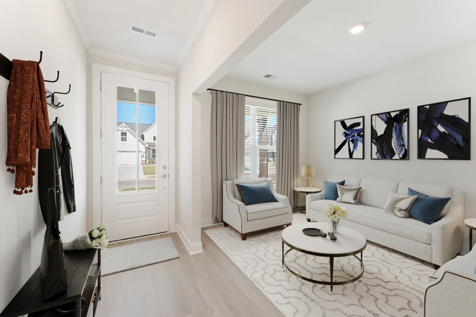 a living room with a white couch and a white table