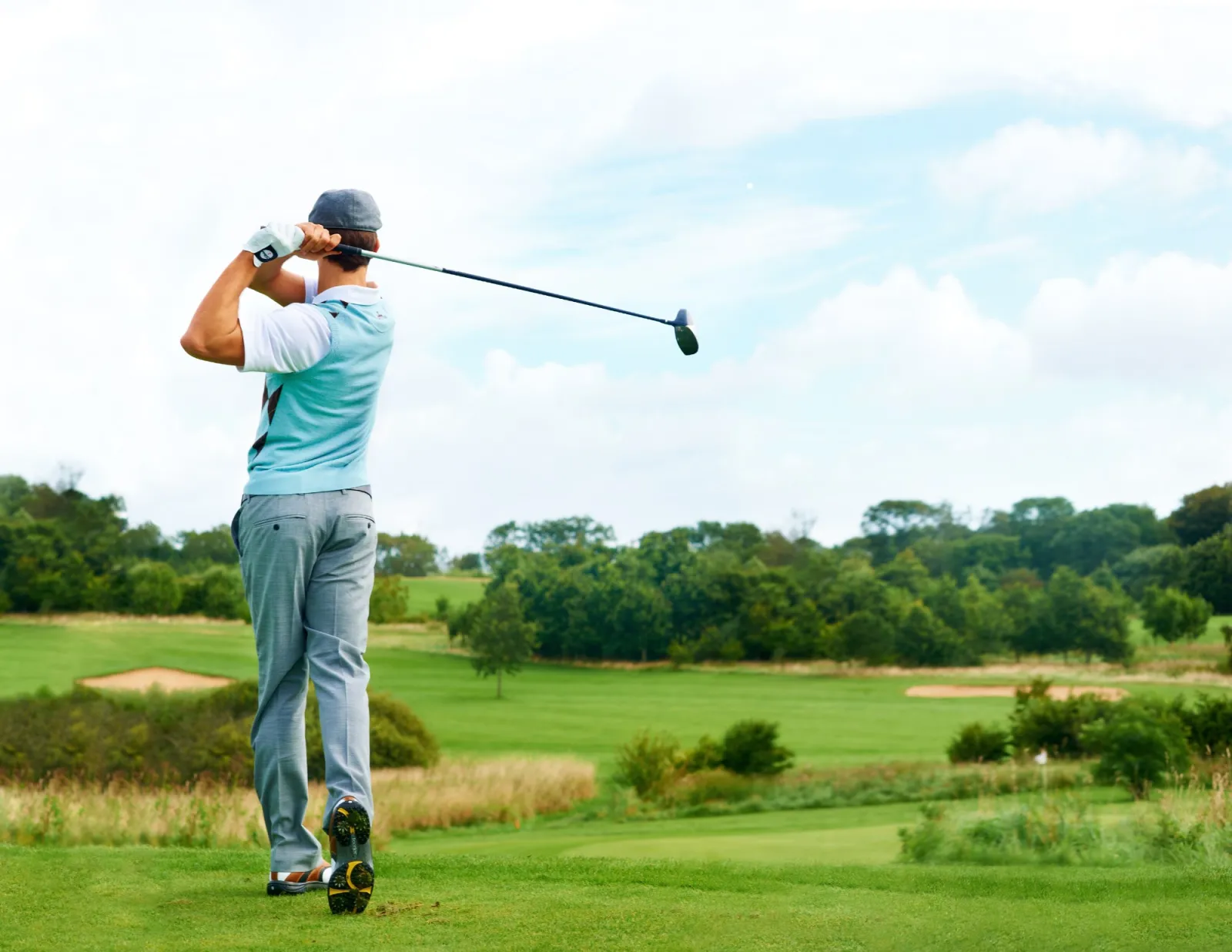 a man who just hit the ball with his club at the golf course