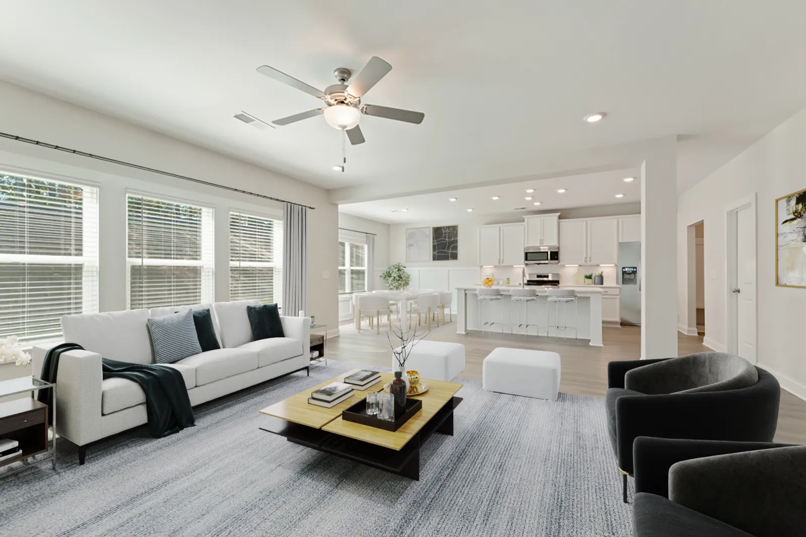 a living room with a large ceiling fan and a couch