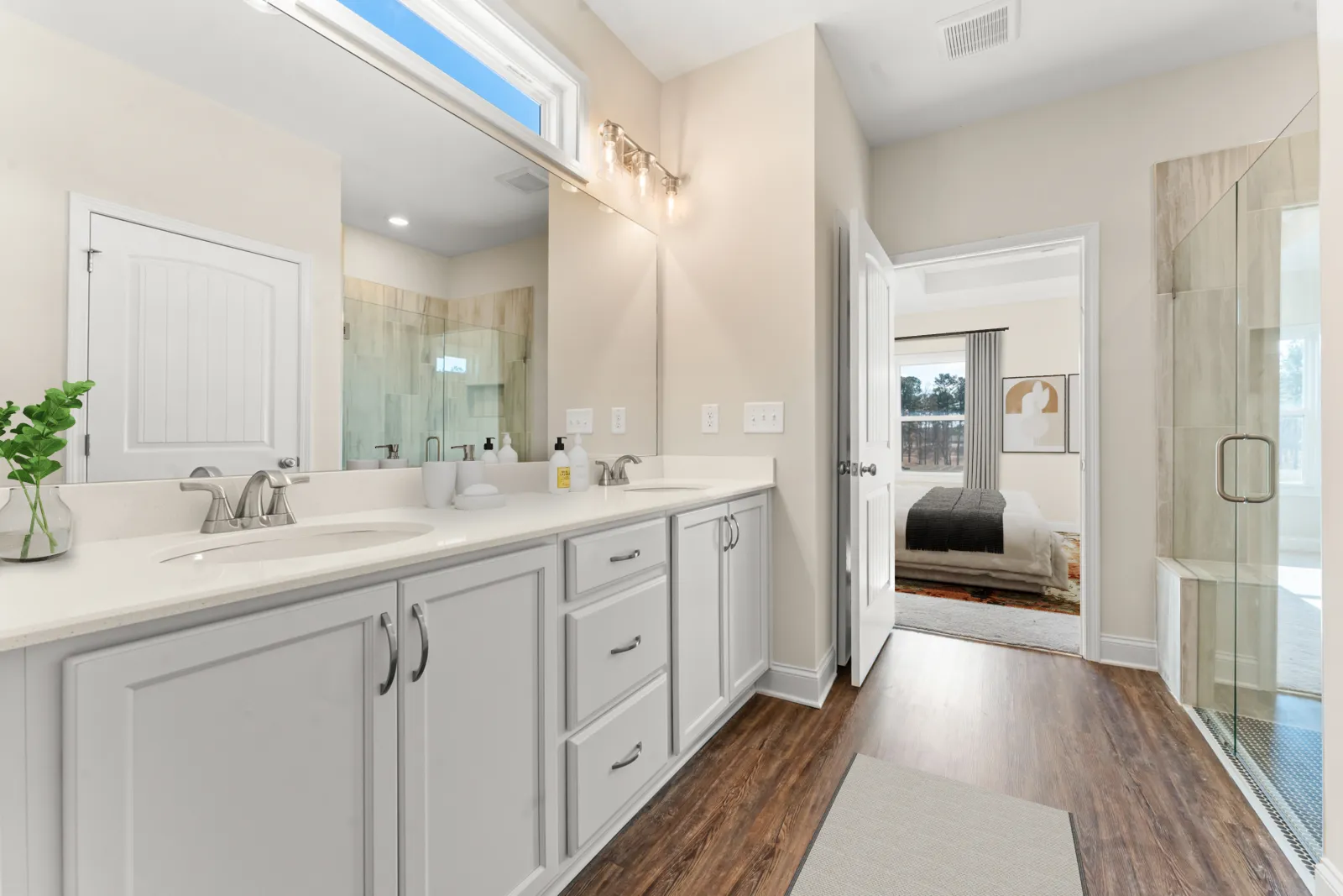 a bathroom with white cabinets