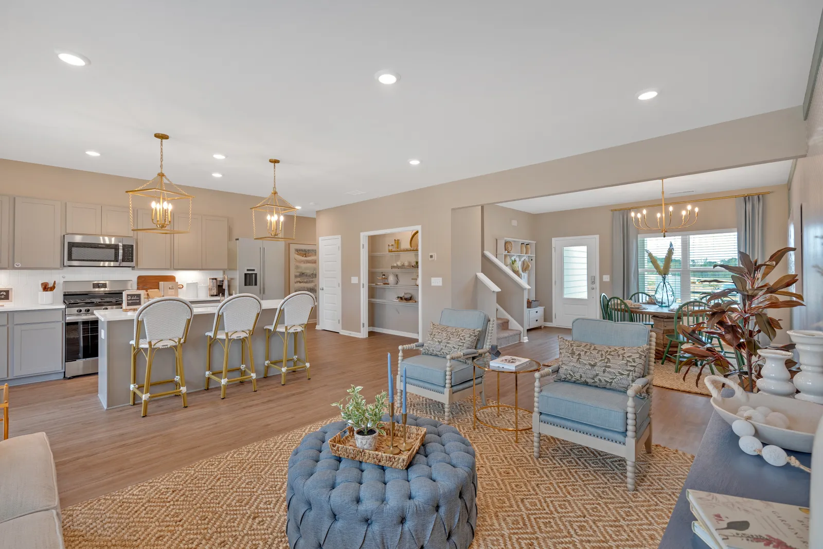 Modern open-concept living room and kitchen with stylish decor and inviting atmosphere.