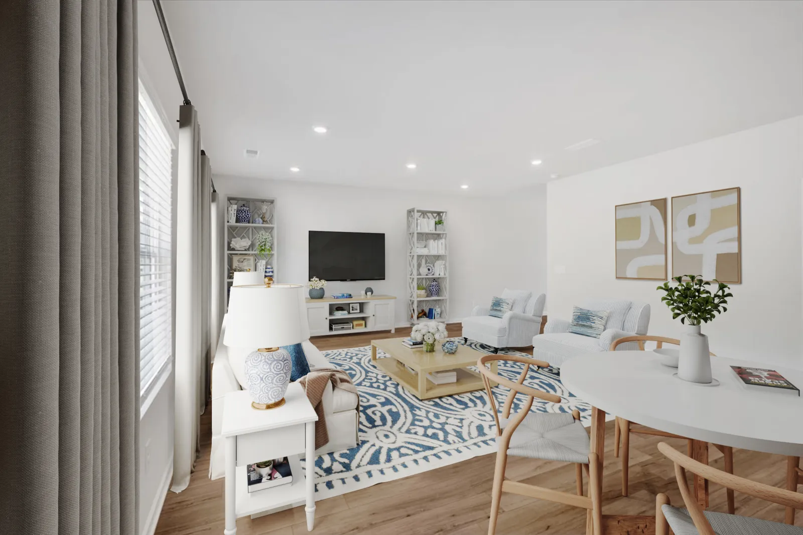 Bright living room with blue patterned rug, white furniture, wooden dining table, and modern TV setup.