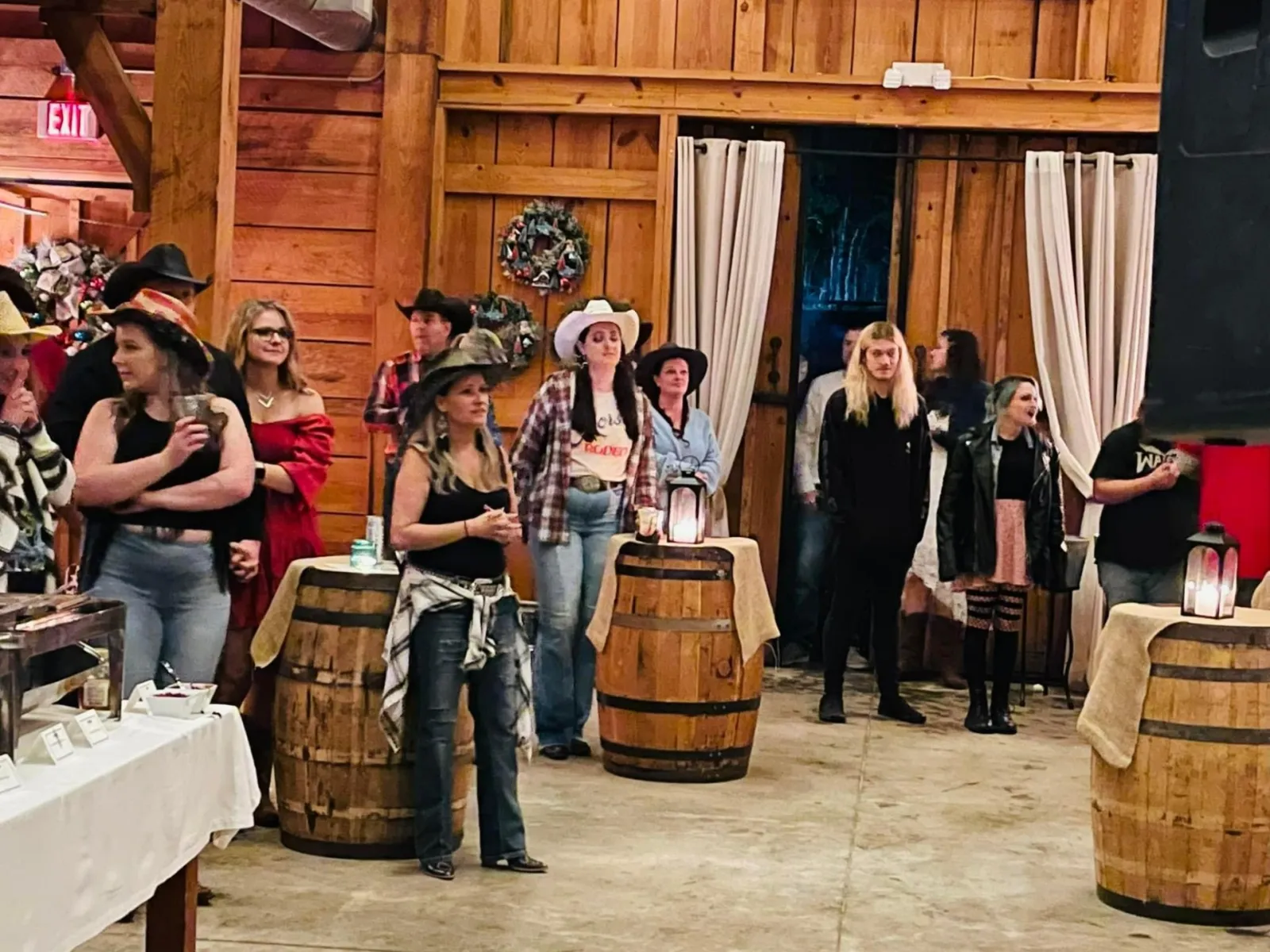 a group of people standing around barrels