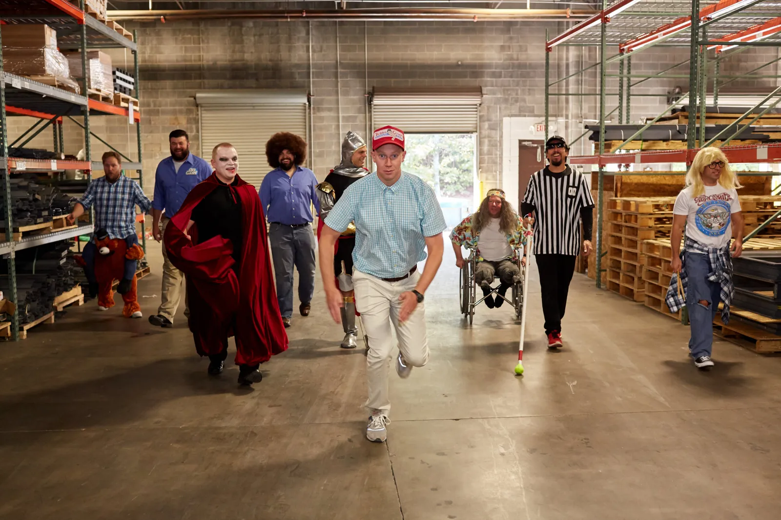 a group of people walking in a warehouse