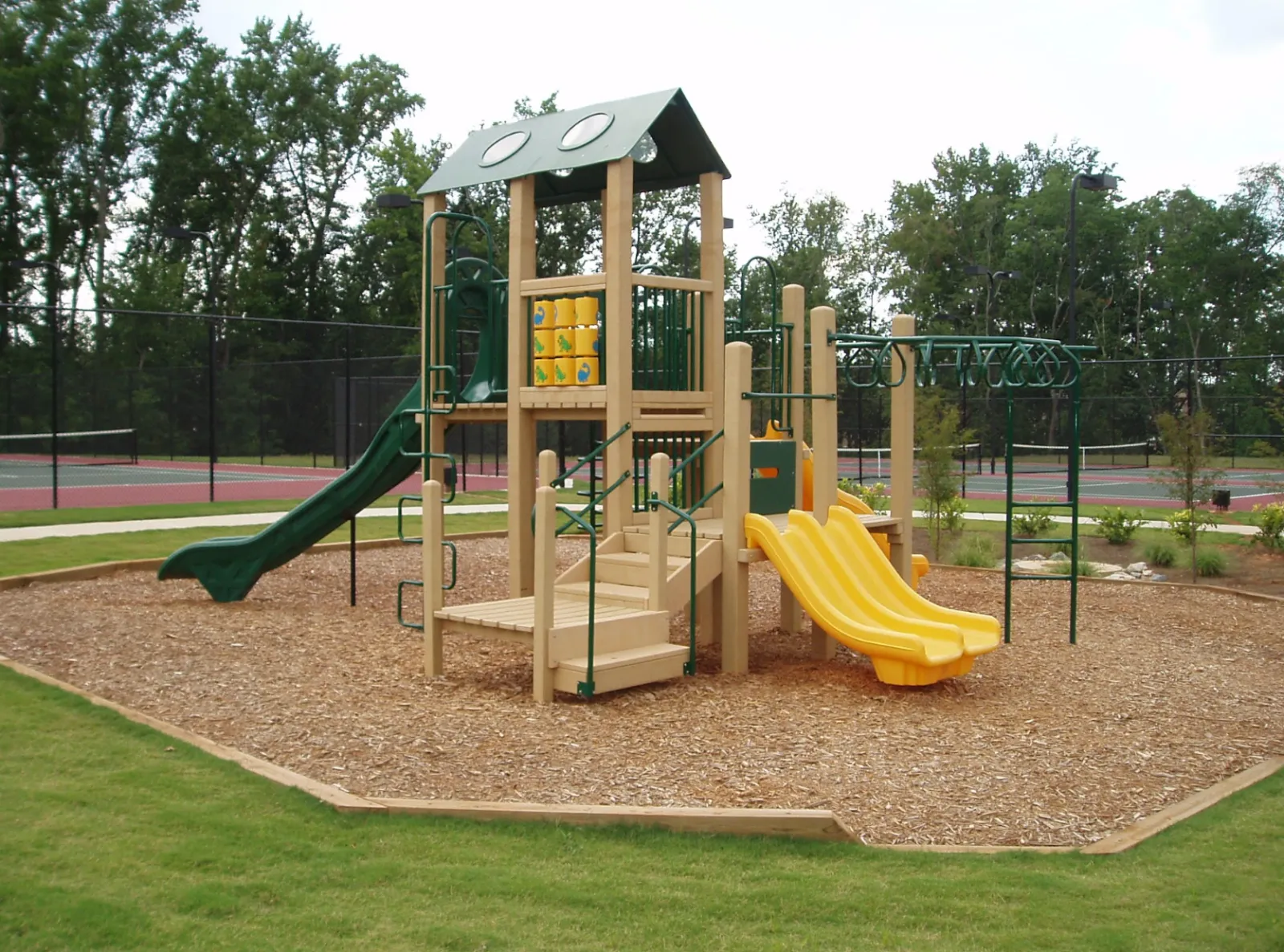 green and yellow ecoplay structure with slides