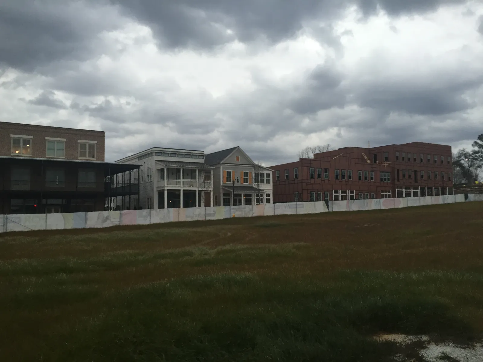 a large building with a grass field in front of it