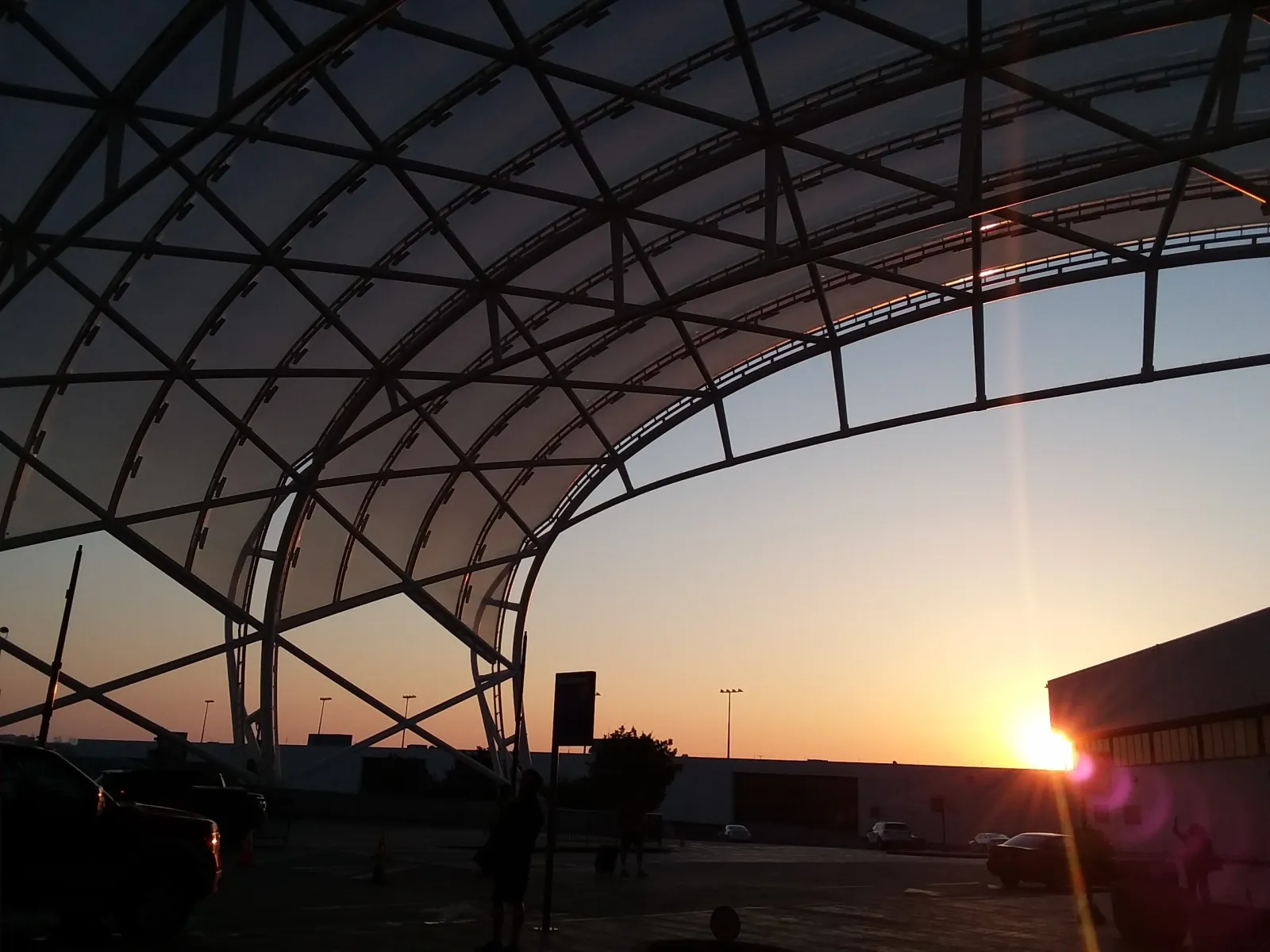 a large glass dome with a sunset