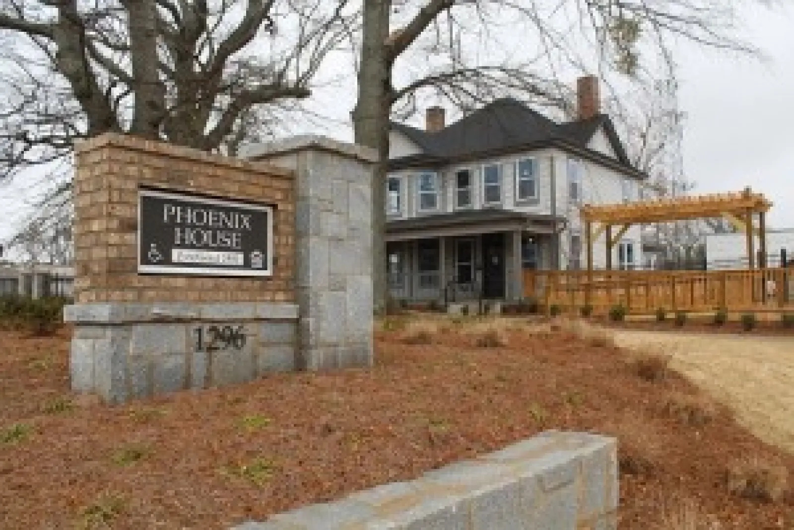 a sign in front of a house