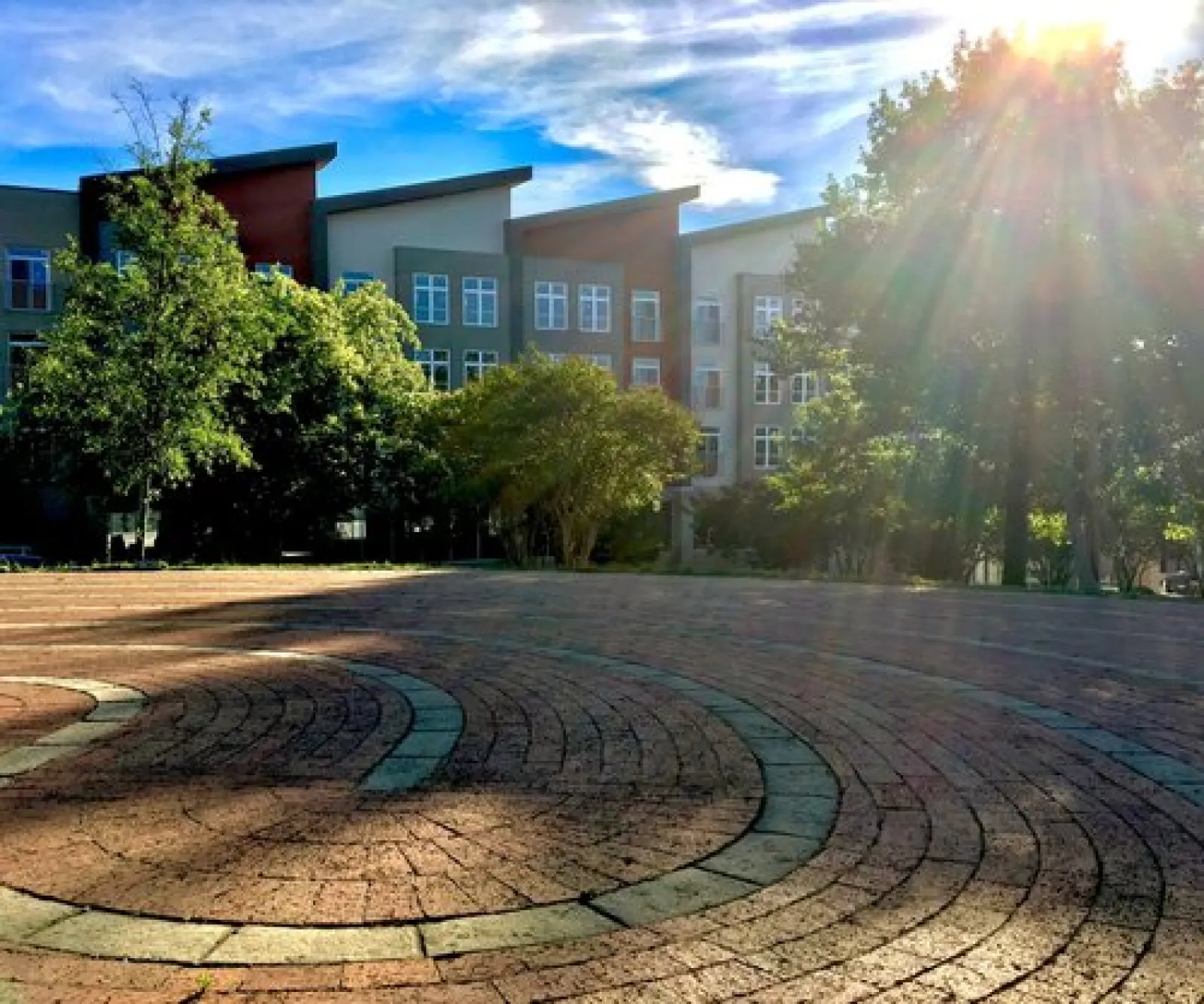 a courtyard with a fountain and trees