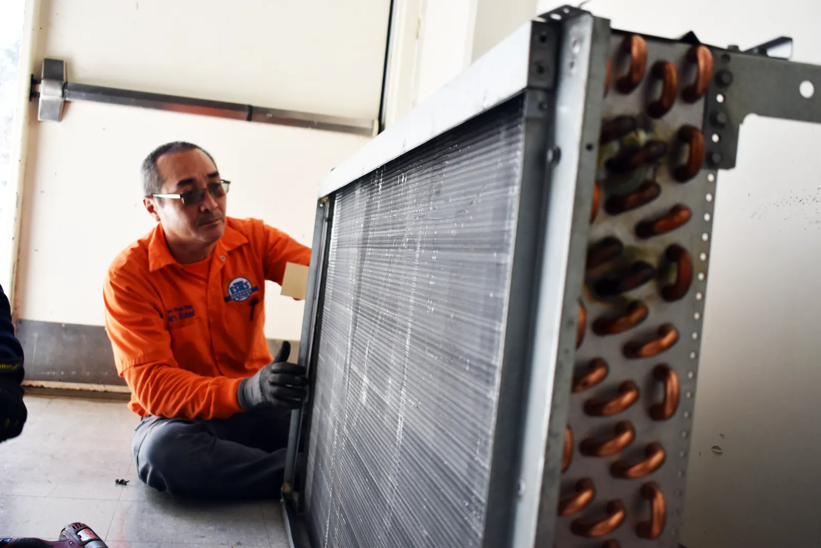 Estes Commercial Technician working on a coil