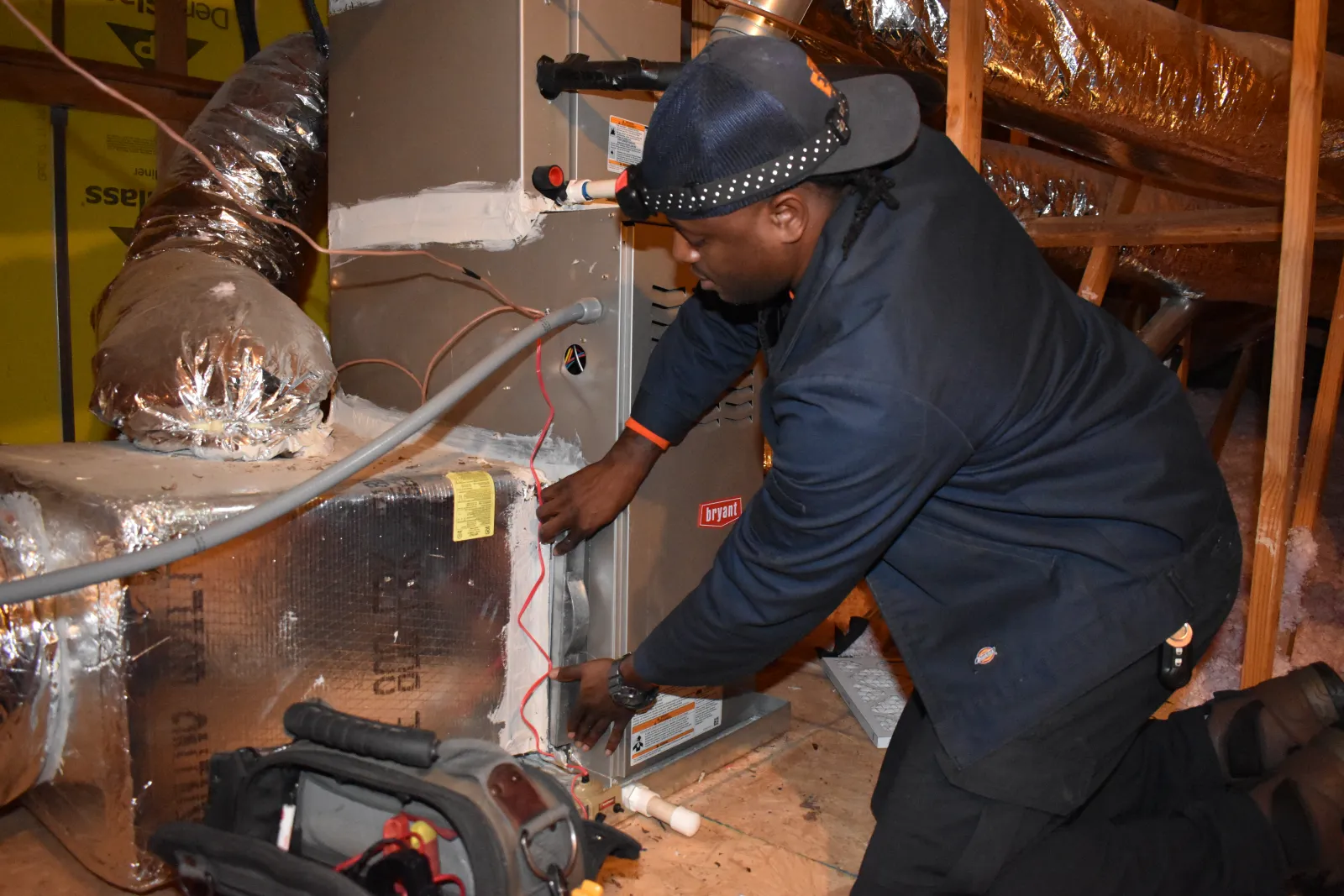 Estes Technician in an Attic working on a Furnace Inspection