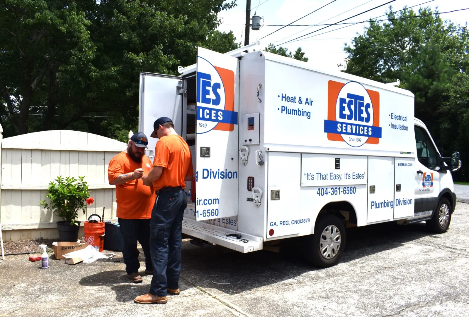 Estes Plumbers in the back of a Plumbing Truck