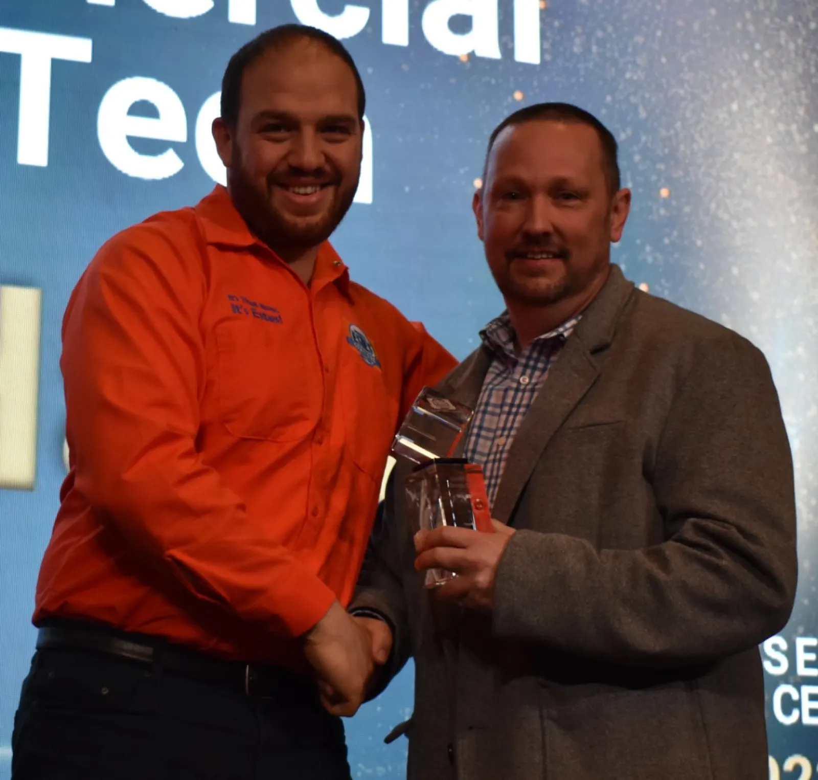 Estes Services Technician receiving an award from his boss