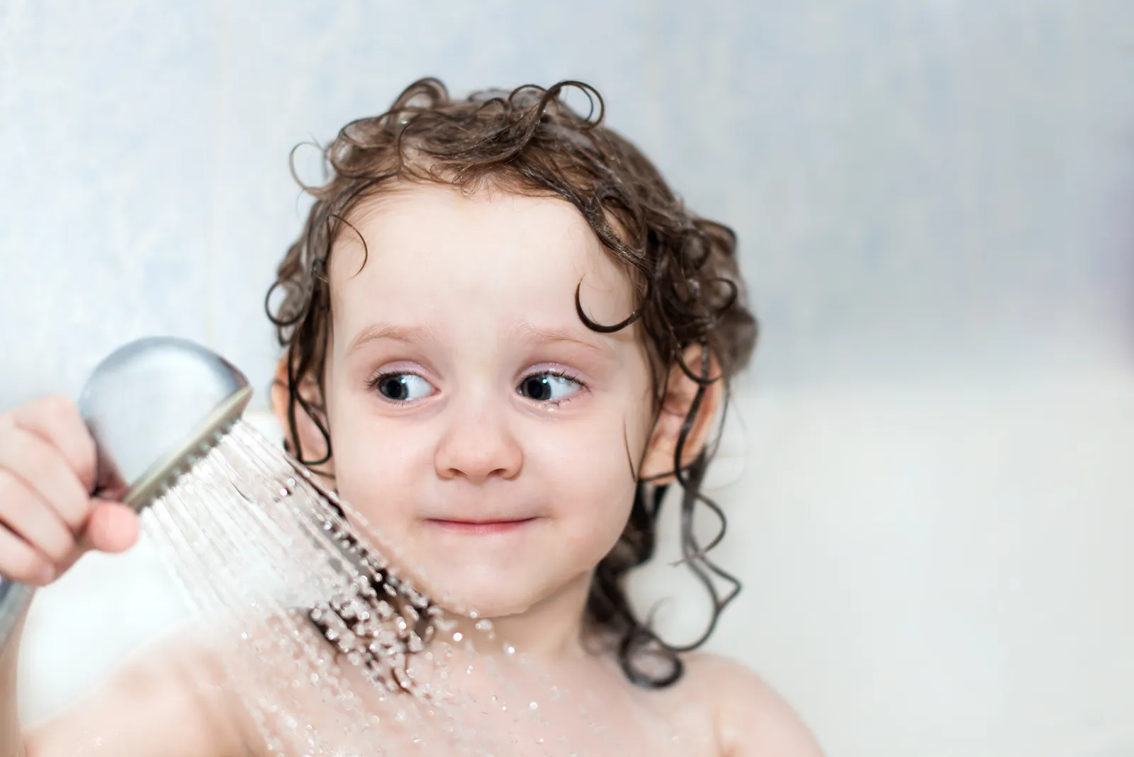 Baby playing in a bathtub