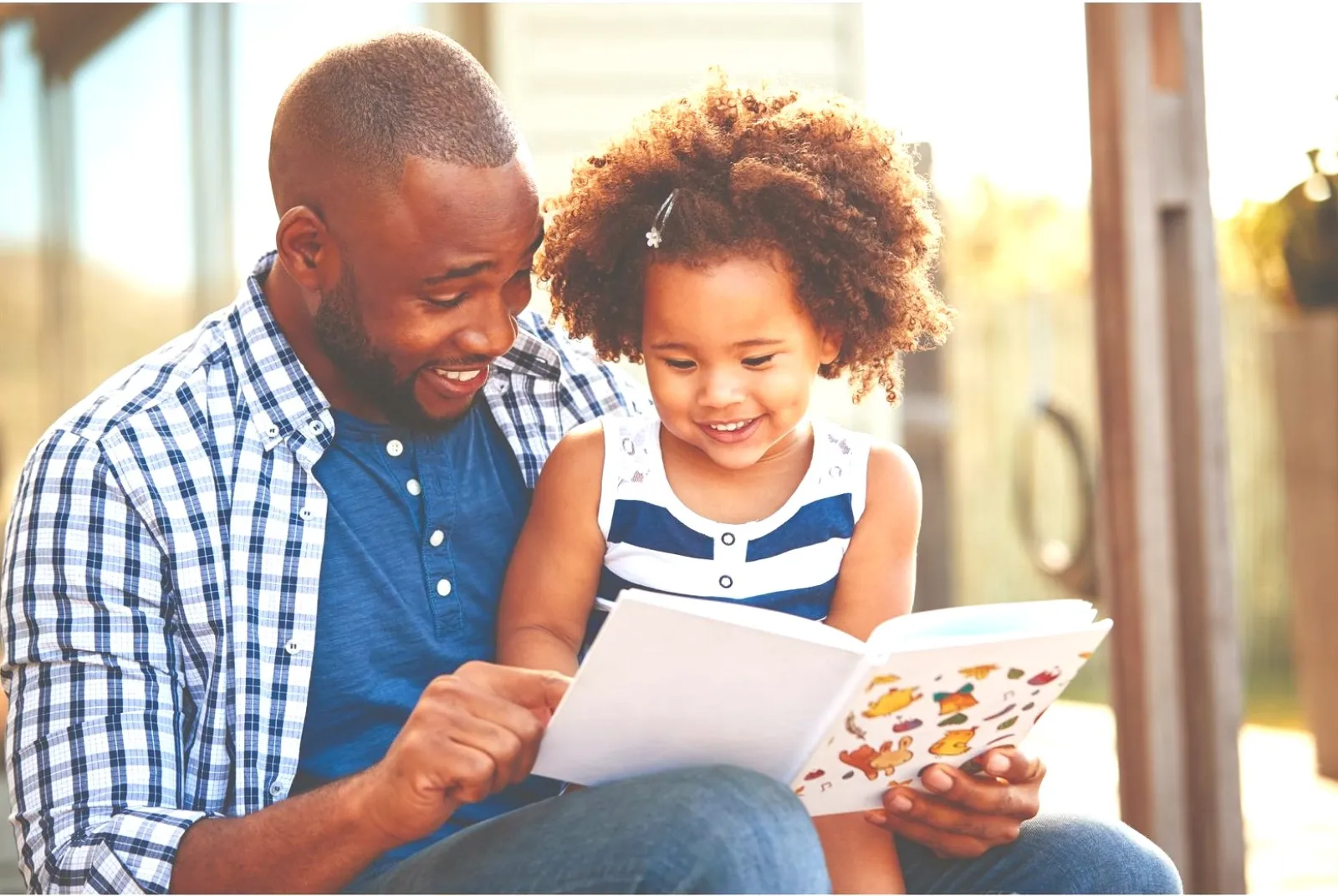 a person and a child reading a book
