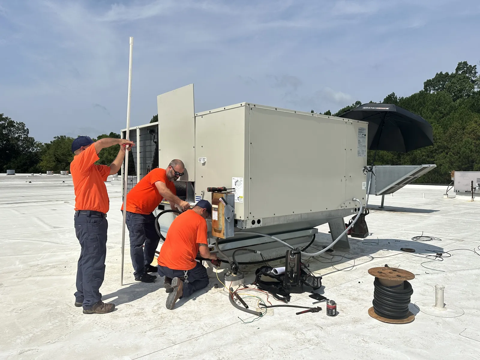 Estes Commercial Team Installing a new HVAC Equipment