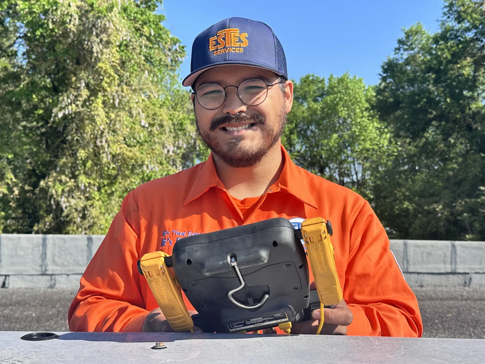 Estes Commercial HVAC Technician smiling in a rooftop