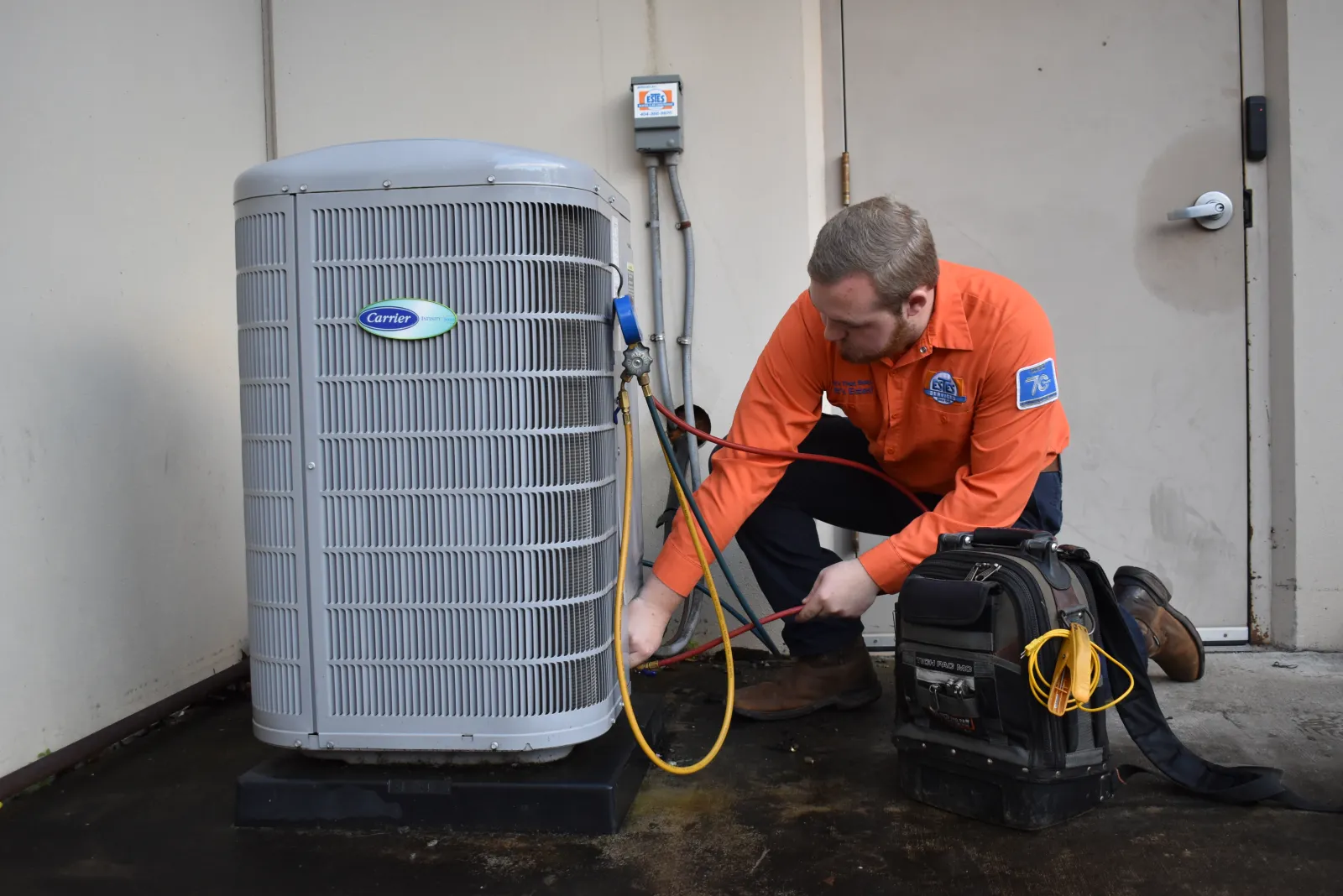 Estes Services Technician working on a hissing noise HVAC unit 
