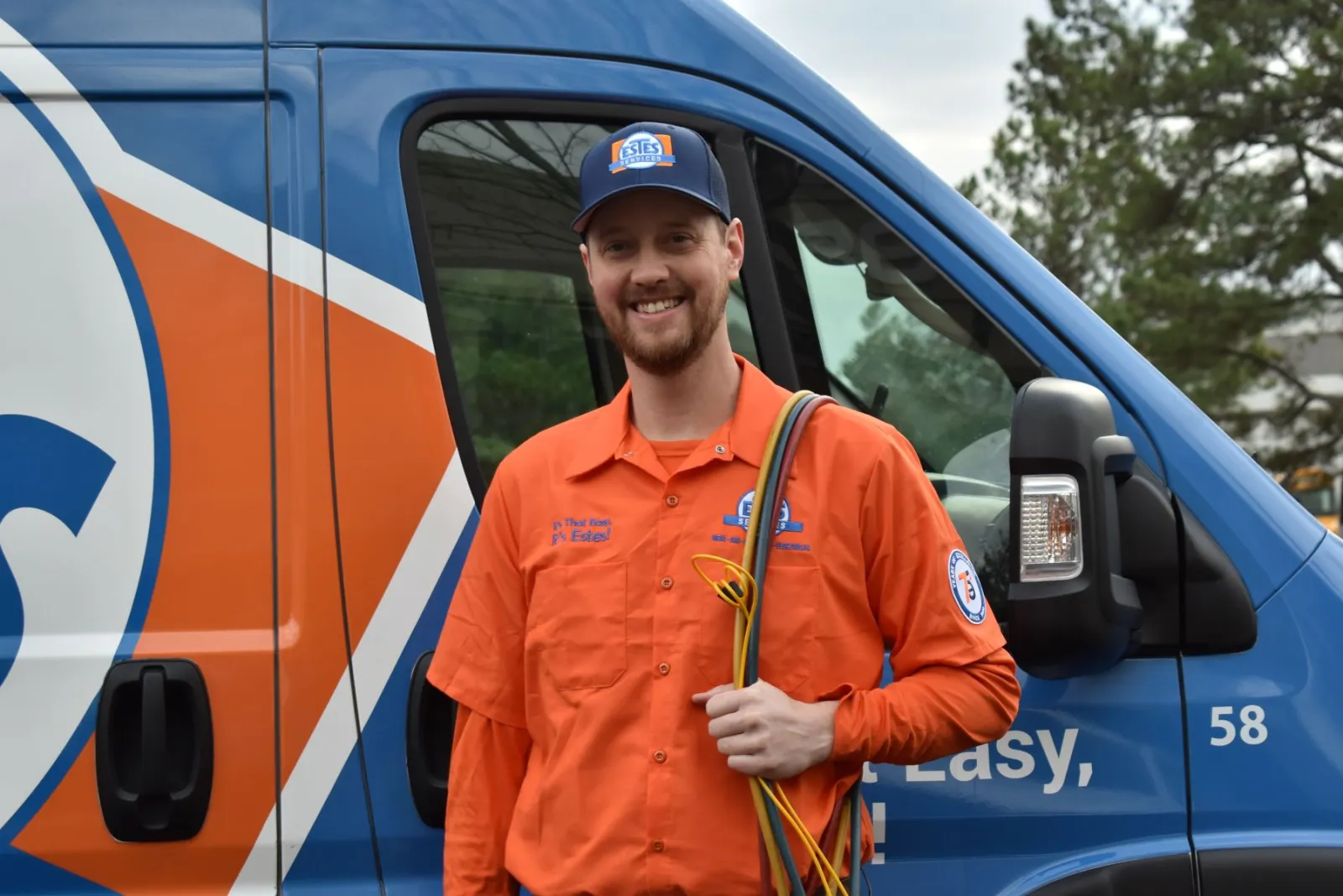 Estes Services Technicians Smiling in front of a truck