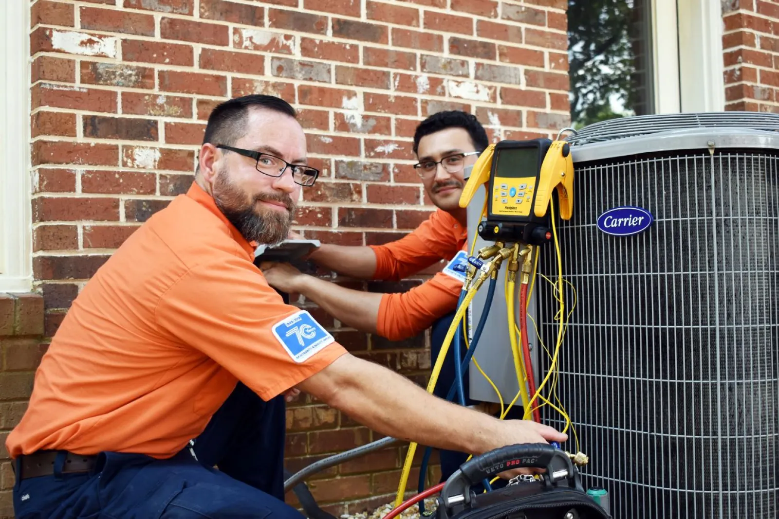 Estes Services Techs working on a Carrier Equipment