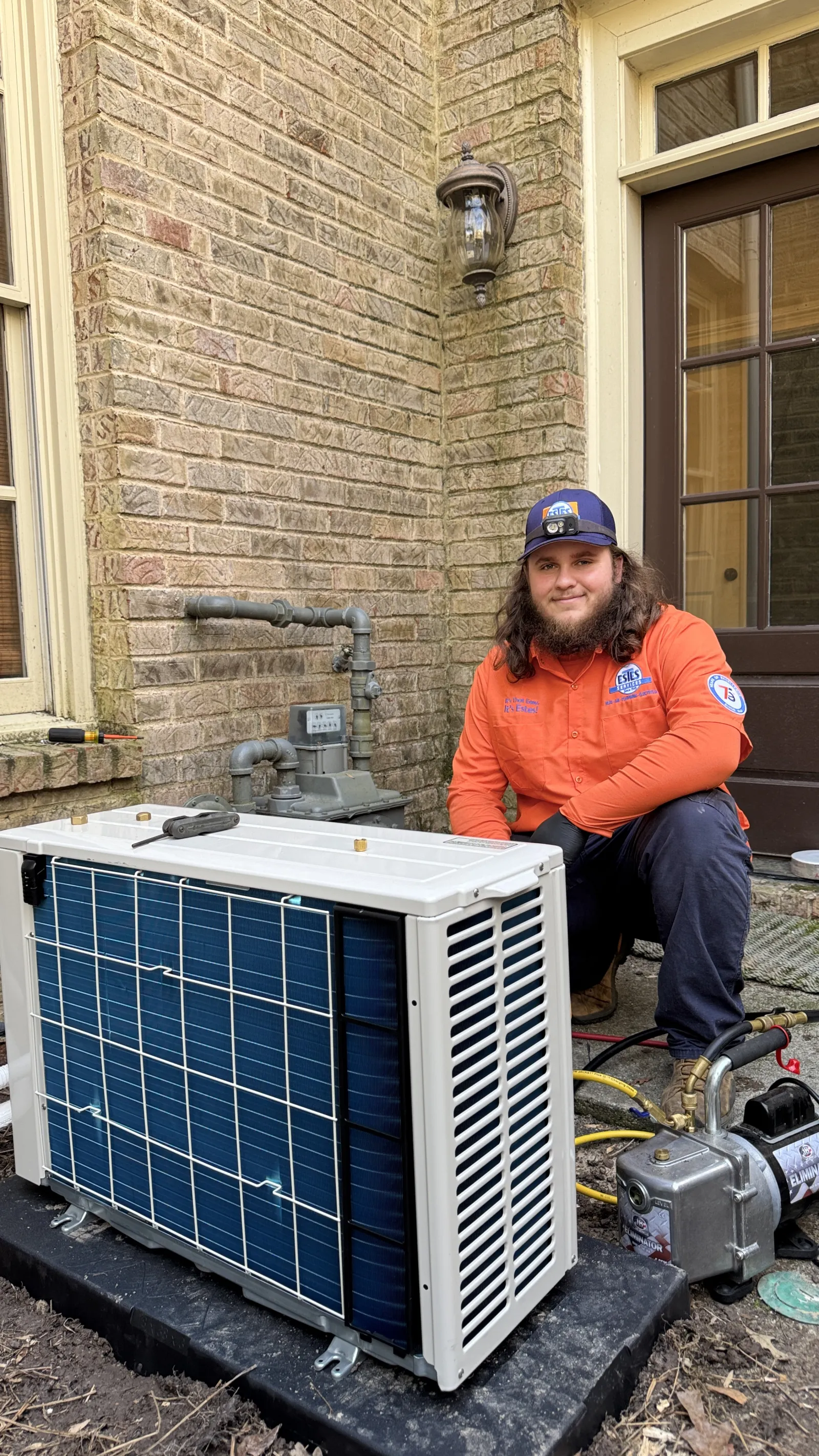Estes Heating and Air technician installing a Mini Split Air Conditioner