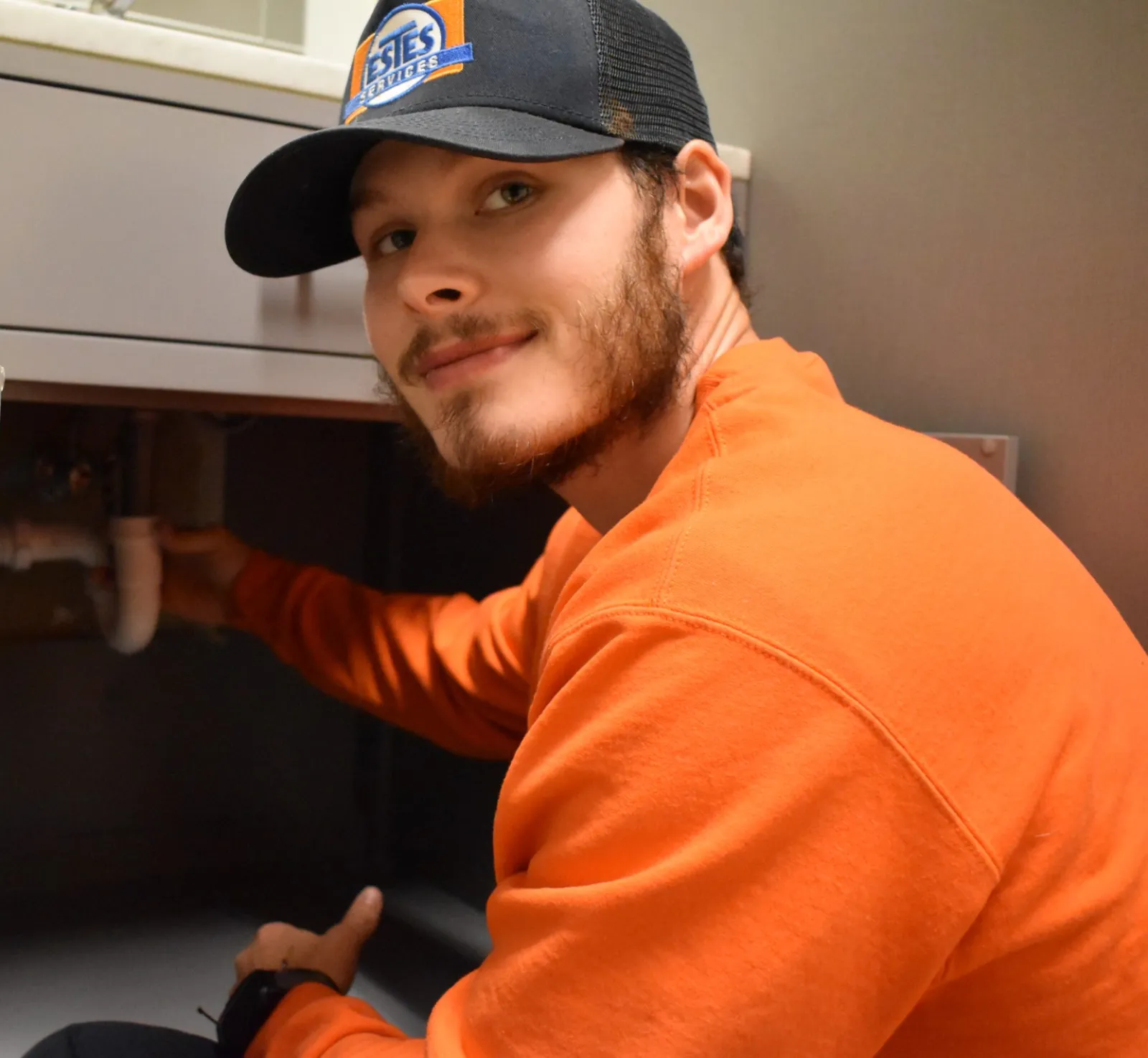 Estes employee checking water filtration system Atlanta