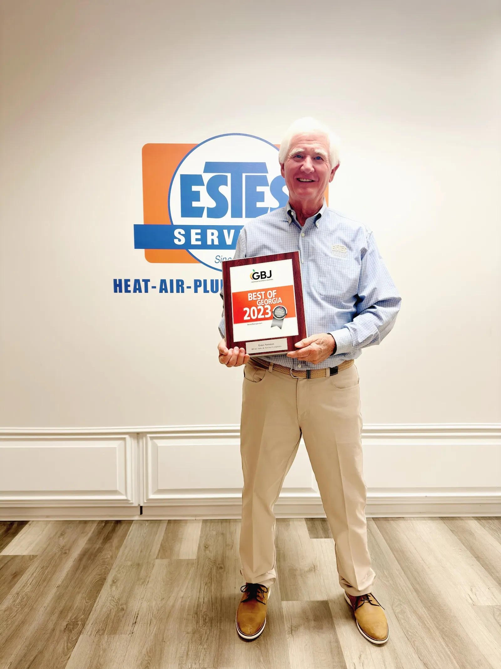 Tommy Estes, CEO of Estes Services holding the plaque of Best of Georgia 2023