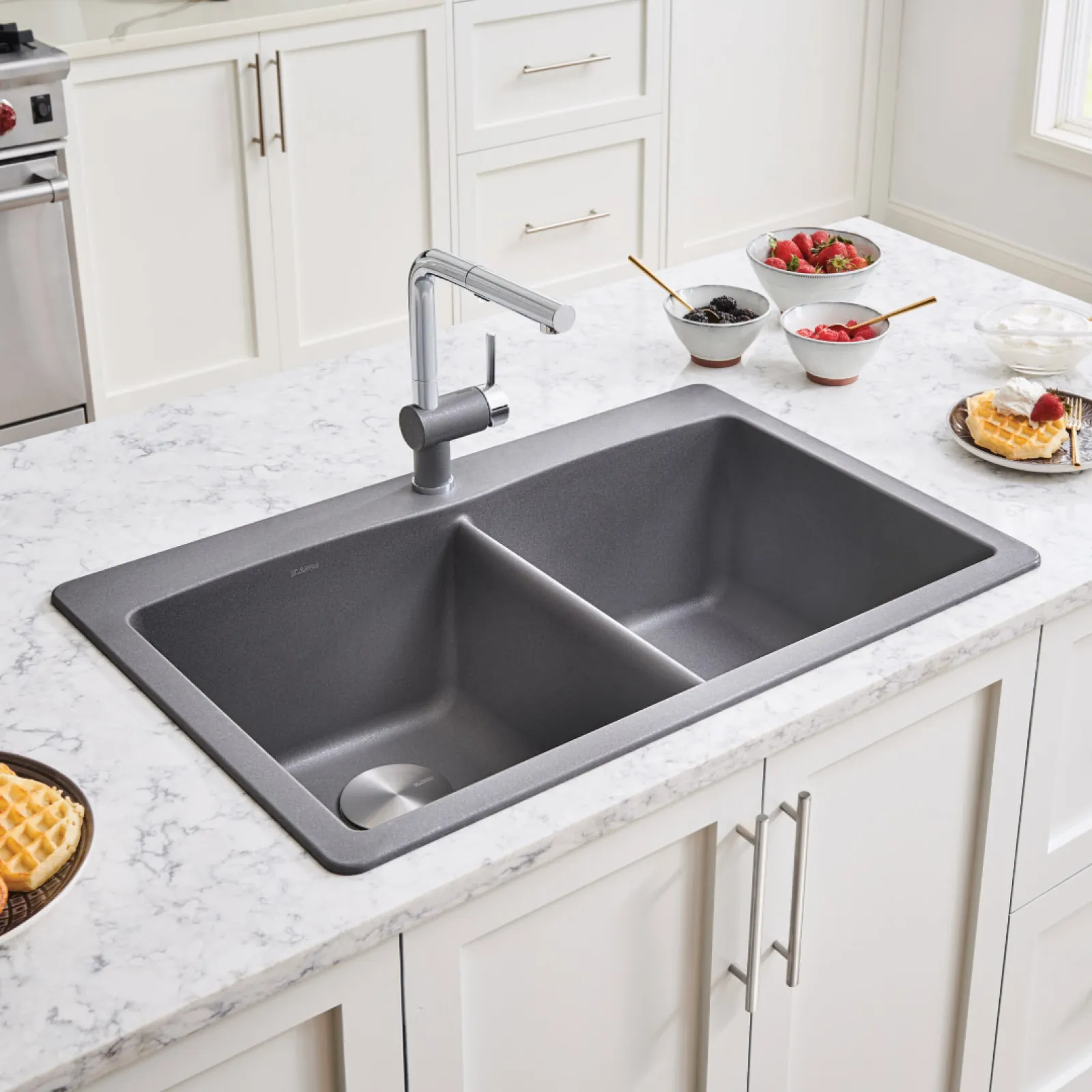 a kitchen sink with a bowl of fruit on top