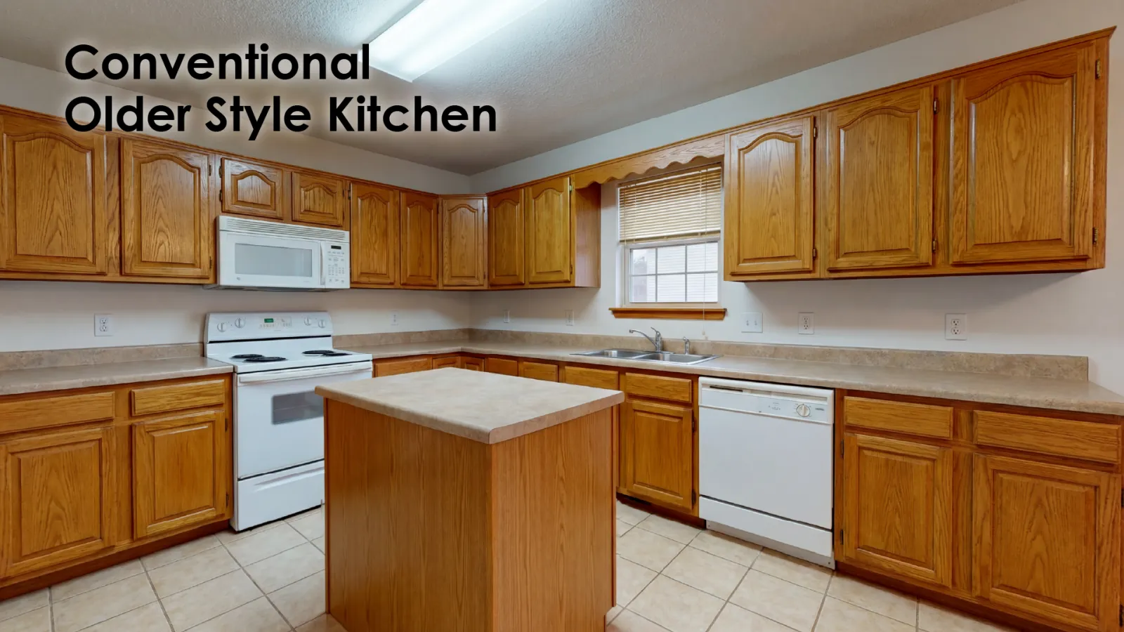 Traditional kitchen with oak wood cabinets, white appliances, tiled floor, and a central island under fluorescent light.