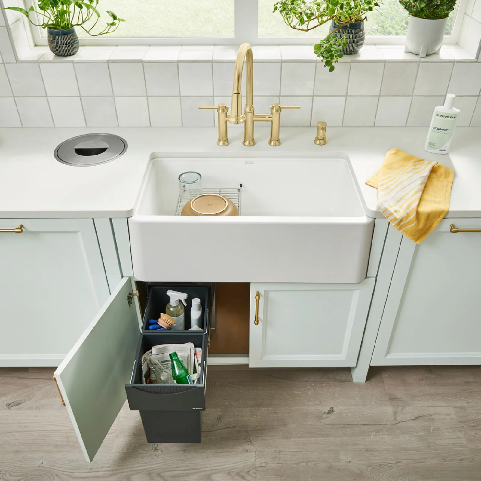 a white sink with a towel from it