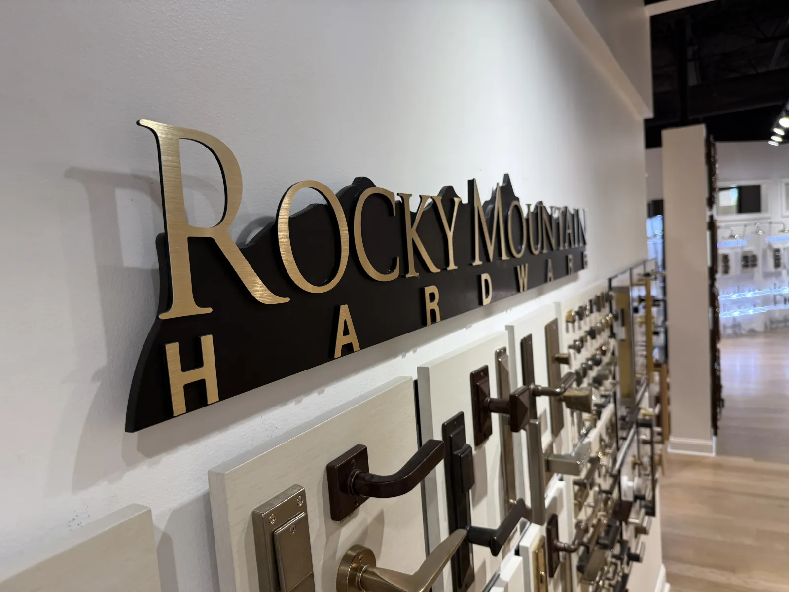 Display wall of various door handles and hardware fixtures at Rocky Mountain Hardware showroom.