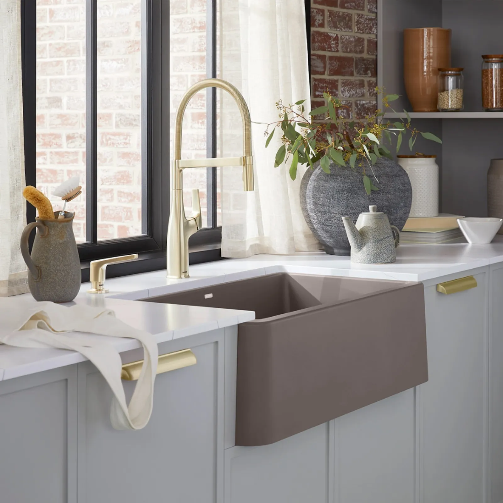 a sink with a mirror and a plant on it