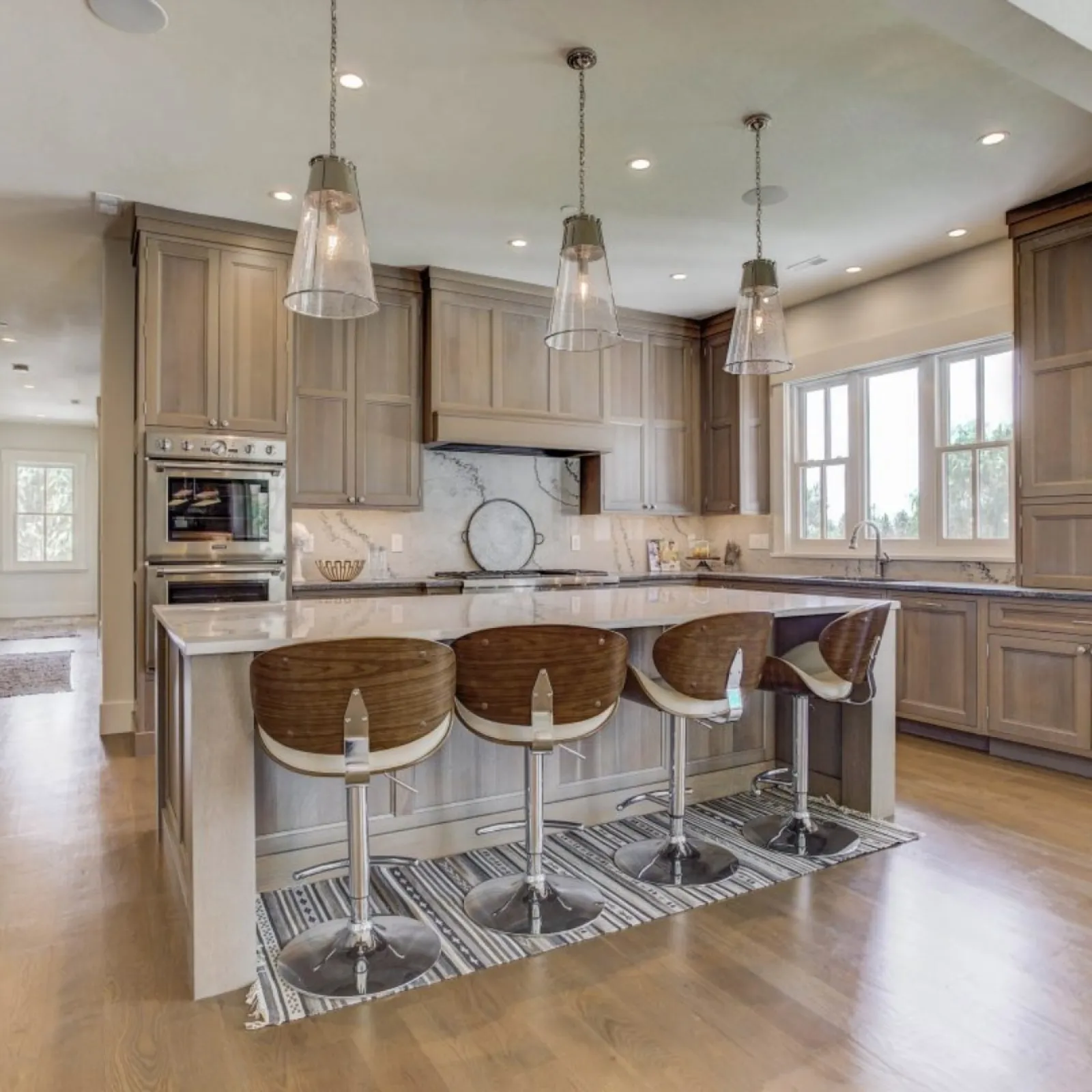 a kitchen with a bar and stools