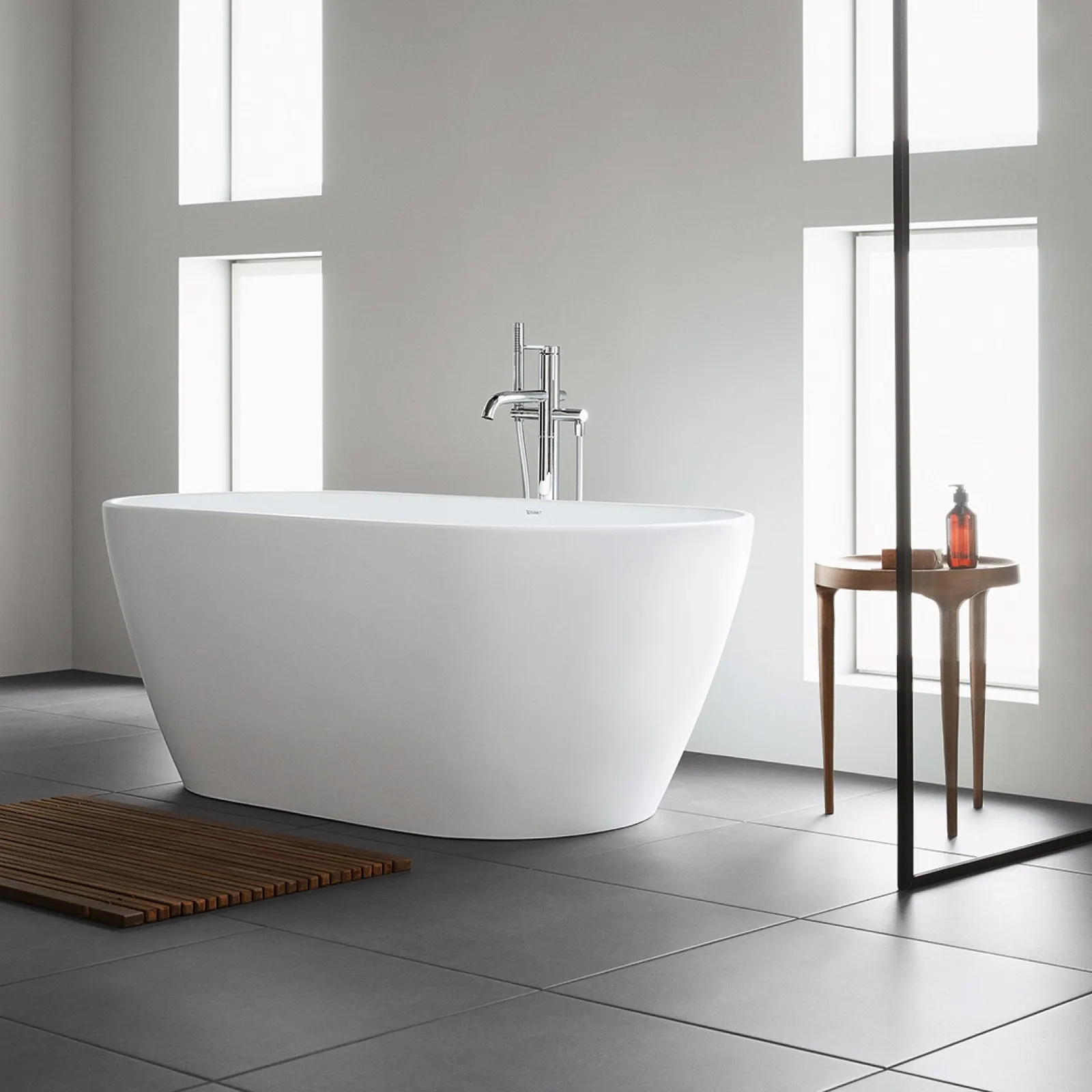 Modern freestanding bathtub in a minimalist bathroom with natural light and elegant decor.